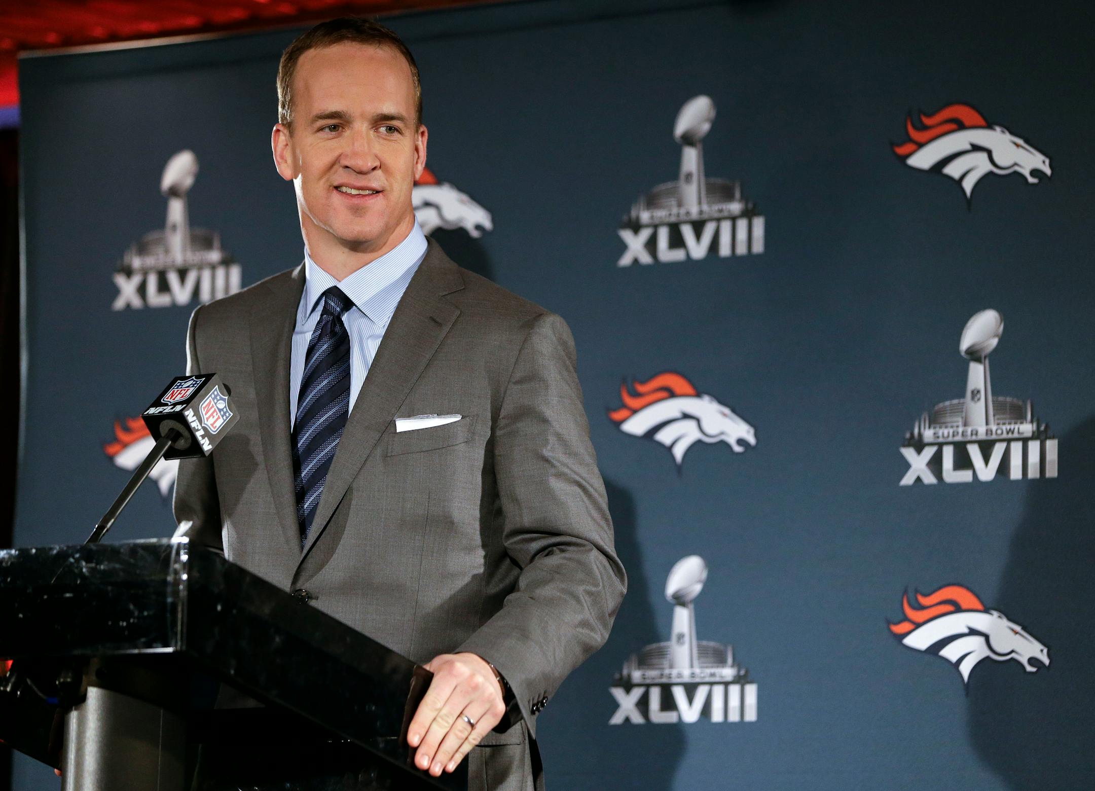 Denver Broncos quarterback Peyton Manning talkeds with reporters during a news conference on Sunday in Jersey City, N.J. Even at age 37, Manning says he still enjoys preparing for games, which leads him to believe he will continue to play this fall.