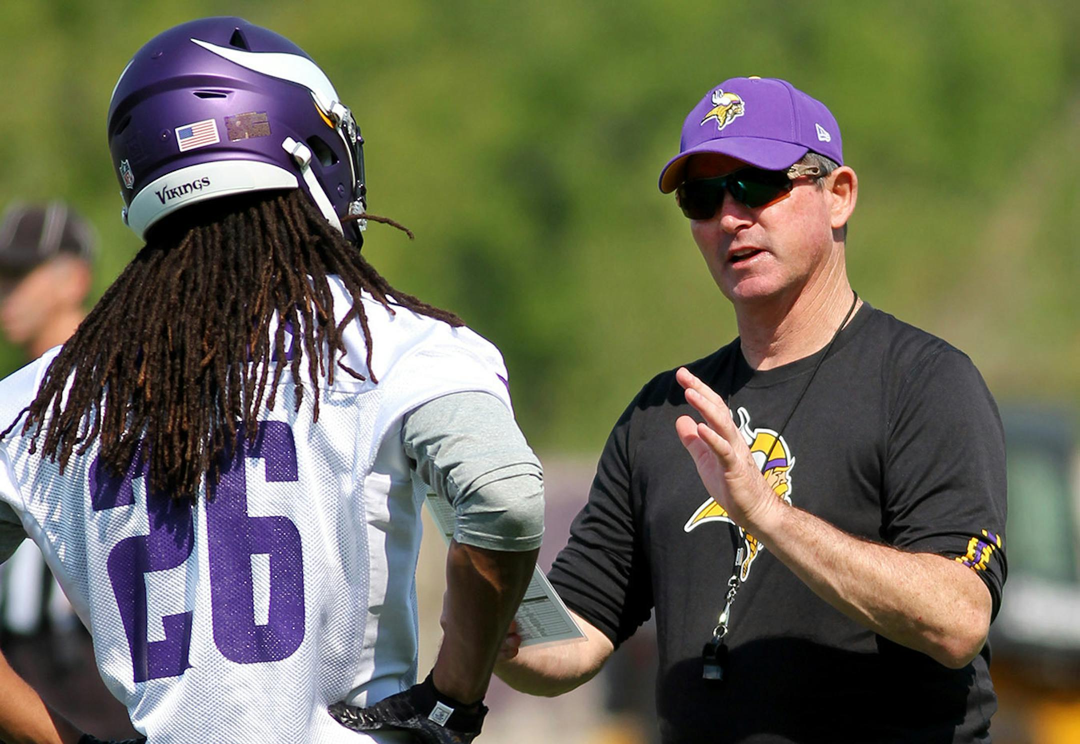 Minnesota Vikings head coach Mike Zimmer talks with Trae Waynes