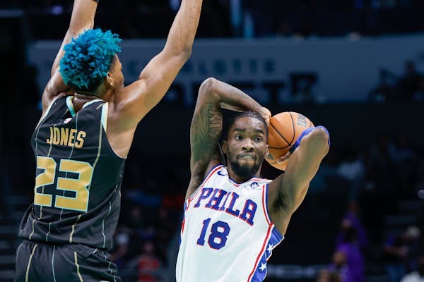 Philadelphia 76ers guard Shake Milton (18) passes around Charlotte Hornets forward Kai Jones (23) during the second half of an NBA basketball game in 