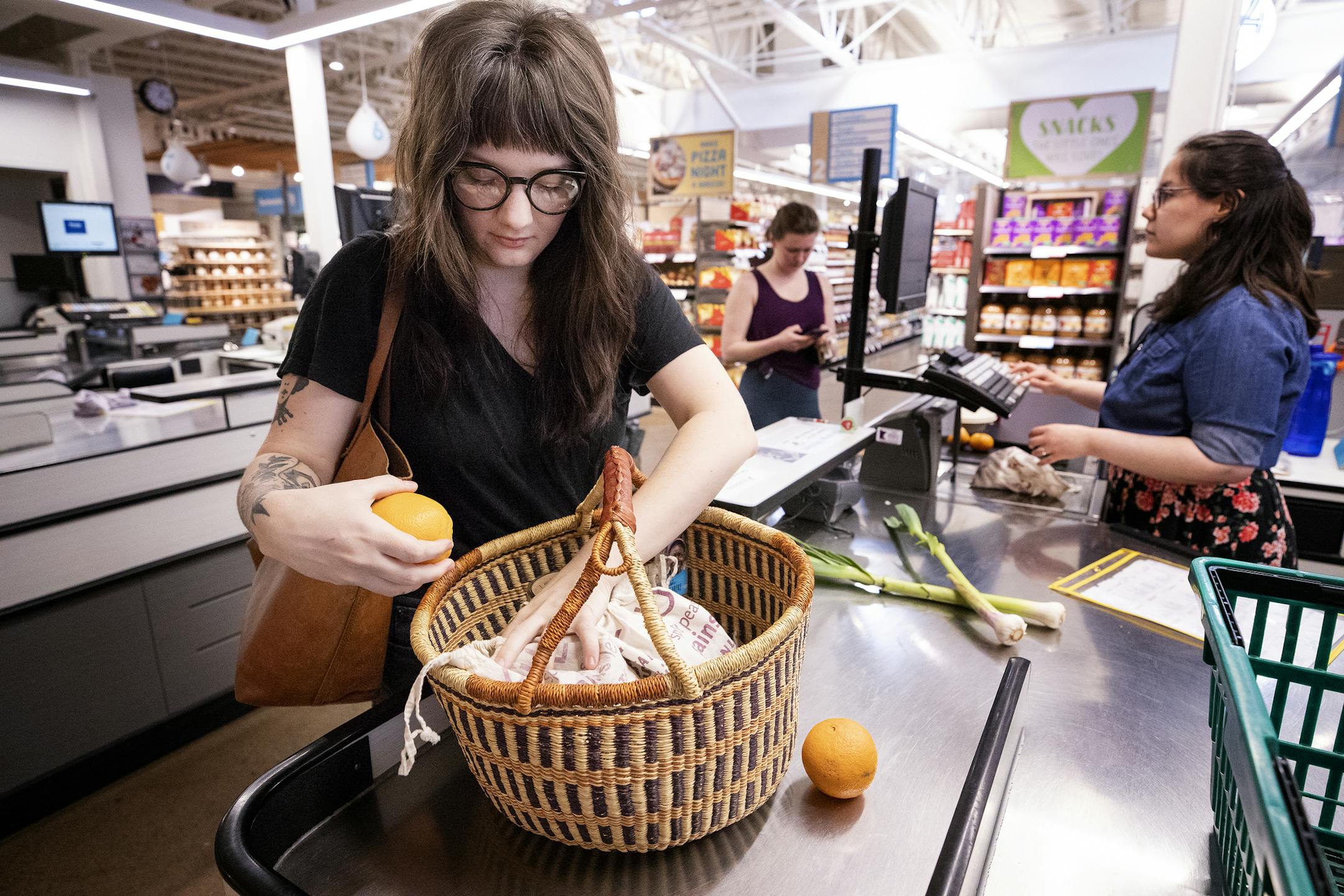 Erika Larson checked out at the Wedge Community Co-op in Minneapolis. Larson is a zero waster. When she shops for food, she buys in bulk, brings a reusable market basket and puts her bulk items into reusable cloth bags.
