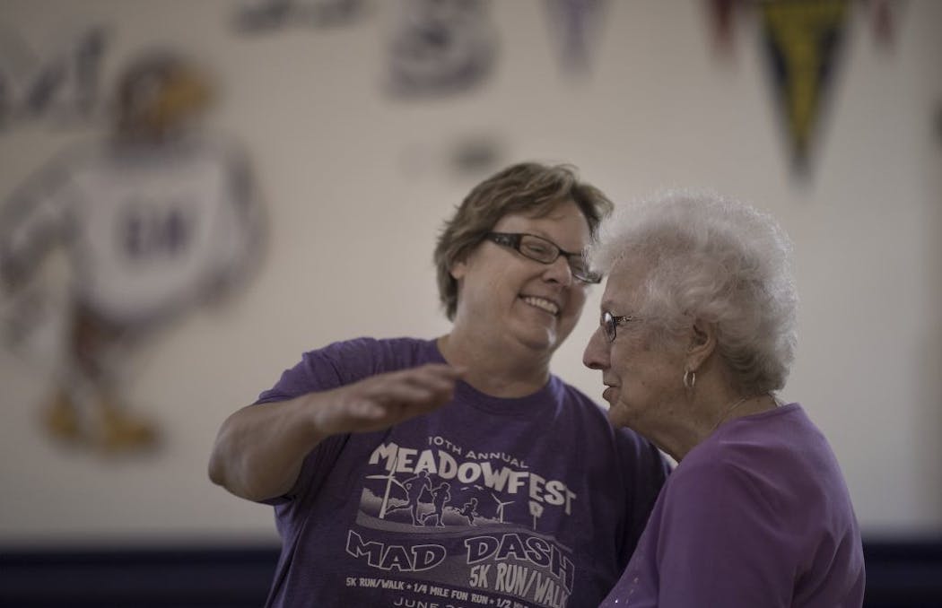 Grand Meadow teacher Dawn Baudoin left hugged 99-year-old Beulah Ankeny who was part of the record-setting Grand Meadow girls' basketball teams of 1929-39, which won 94 consecutive games Thursday July 12, 2018 in Grand Meadow , MN.
