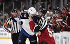 Linesman Ryan Galloway tried to separate Jets defenseman Ben Chiarot (7) and Wild defenseman Christian Folin (5) during a fight in the third period in