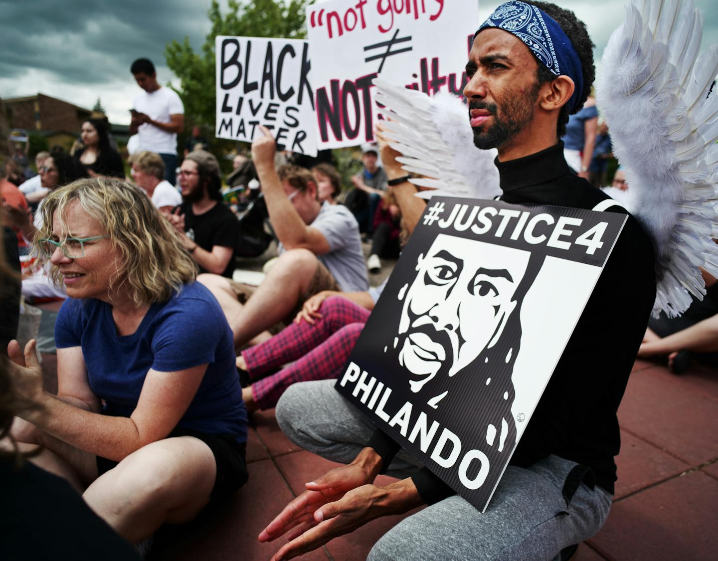 Protesters gathered at Silver Lake Village Shopping Center. Abdi Iman, of Eden Prairie dressed as an angel and said,&#x201d;Philando is looking down as an angel. He should be here on Father&#x2019;s day.&#x201d;] Father&#x2019;s Day memorial rally in honor of Philando Castile will be held noon-3 p.m. Sunday in front of St. Anthony police HQ.