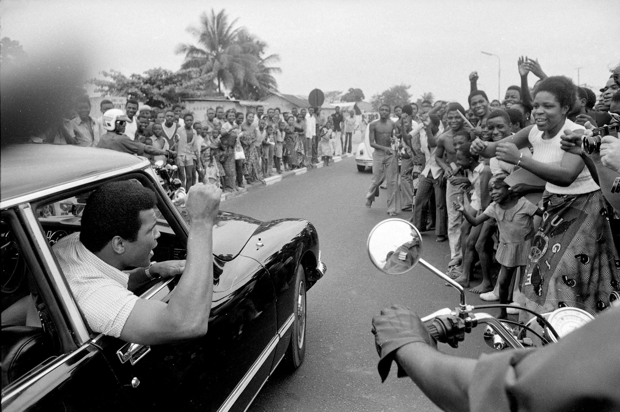 Muhammad Ali is cheered by Zaire admirers as he drives in downtown Kinshasa for a sightseeing trip, Sept. 17, 1974. Ali is in Zaire to face George Foreman.