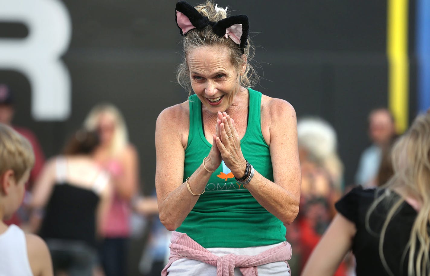 Ann Fink, yoga instructor lead some =kids in cat posses before the start of the Cat Video Festival hosted by the Walker Arts Center. ] (KYNDELL HARKNESS/STAR TRIBUNE) kyndell.harkness@startribune.com Cat video festival at CHS Field in St Pauls, Min., Wednesday August 12, 2015. ORG XMIT: MIN1508121959530093