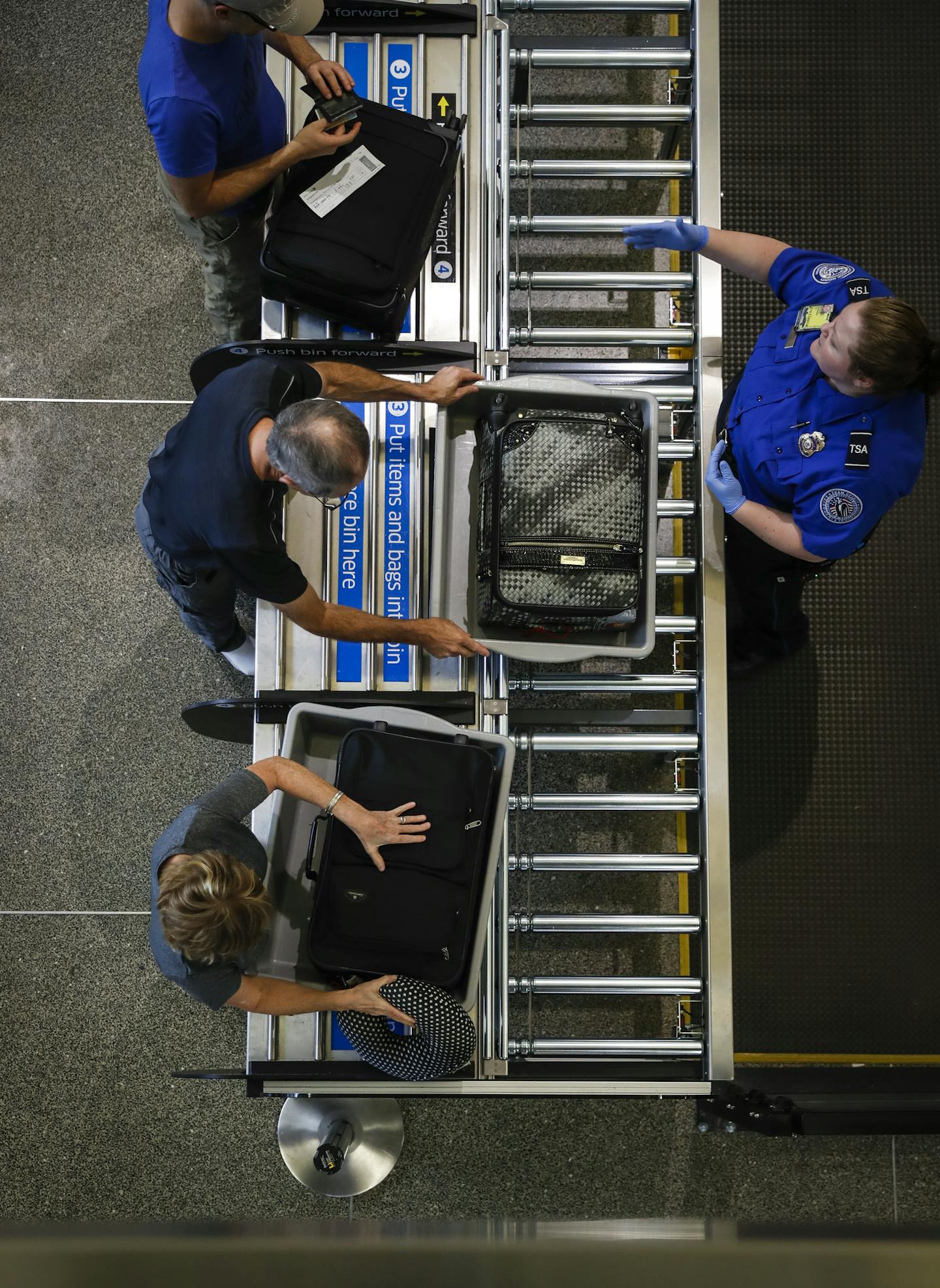 Passengers loaded their luggage into the new larger bins meant for all the luggage including suitcases at the South TSA checkpoint at Terminal 1 at the Minneapolis/St. Paul international airport on Tuesday, September 19, 2017, in Bloomington, Minn. Once passengers load their luggage they push it forward onto a moving rack that brings it through the security imaging. ] RENEE JONES SCHNEIDER &#x2022; renee.jones@startribune.com