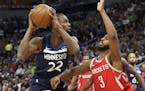 Minnesota Timberwolves' Andrew Wiggins, left, looks for help as Houston Rockets' Chris Paul defends in the first half during Game 3 of an NBA basketba
