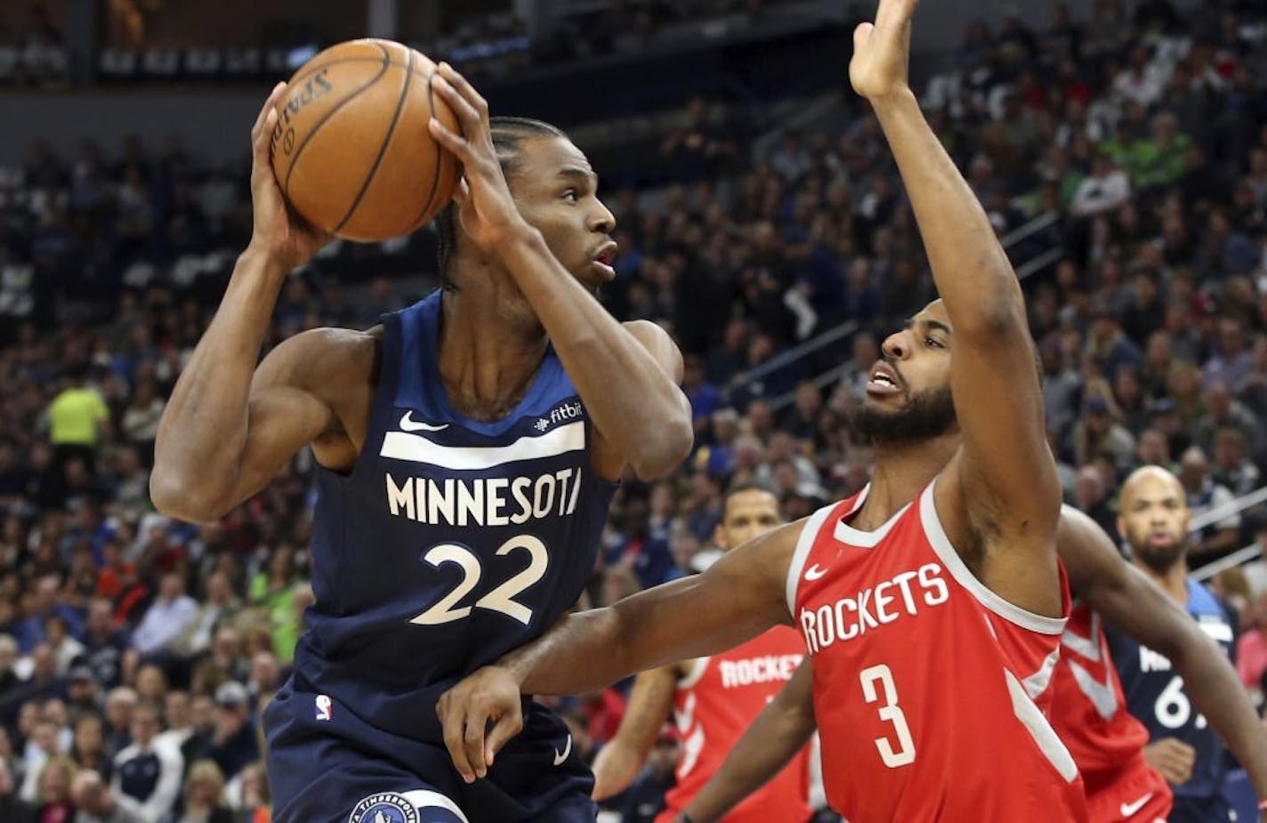 Minnesota Timberwolves' Andrew Wiggins, left, looks for help as Houston Rockets' Chris Paul defends in the first half during Game 3 of an NBA basketball first-round playoff series Saturday, April 21, 2018, in Minneapolis. (AP Photo/Jim Mone4