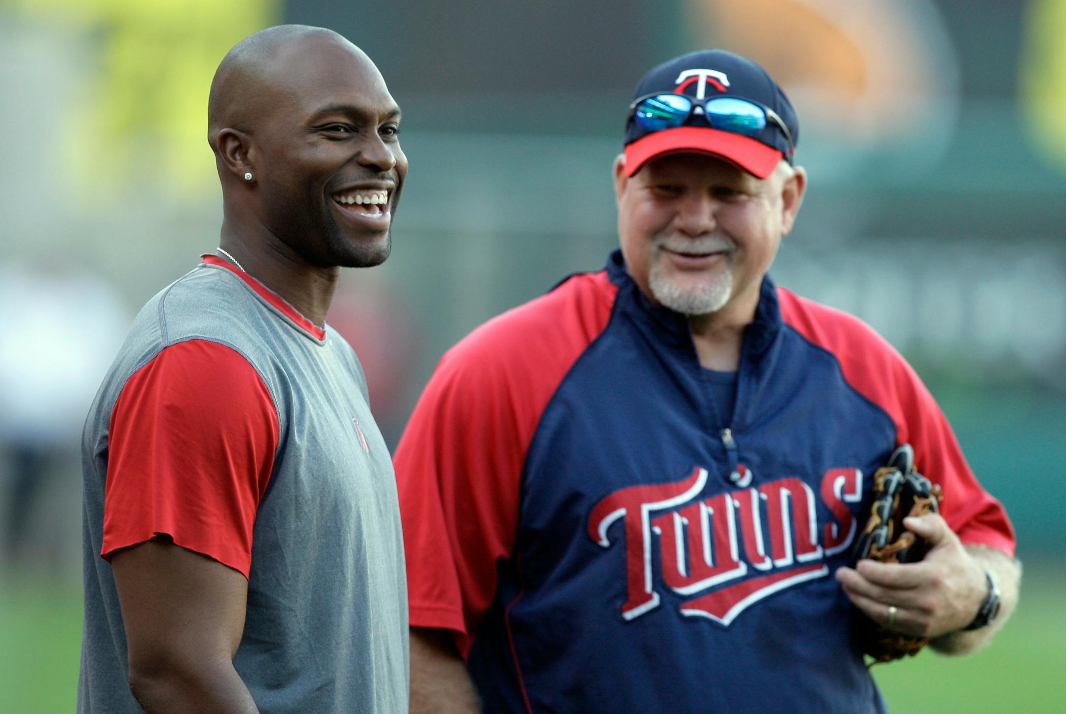 Los Angeles Angels center fielder Torii Hunter talks with Minnesota Twins manager Ron Gardenhire before their baseball game in Anaheim, Calif., Thursday, Aug. 21, 2008.