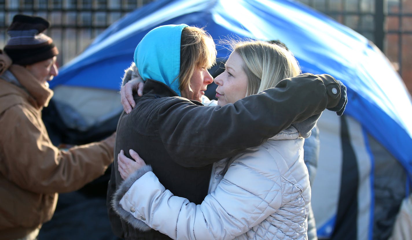 St. Paul officials began clearing out the St. Paul homeless near the Cathedral of St. Paul Wednesday, Nov. 15, 2018, in St. Paul, MN. Here, Michelle Stevens, left, who has been homeless for 13 years, gets a hug from homeless advocate Stephanie Stuart. Stevens said she would look for another camping site in the city in plain sight. "I'm not gonna hide," she said, "I'm to there for the world." Ash Stevens walked off she told the advocate: "Keep your head up."] DAVID JOLES &#x2022; david.joles@star