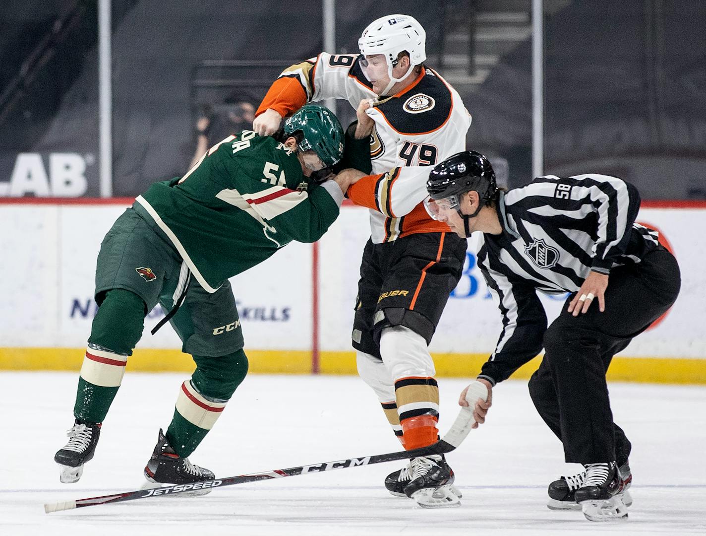 Joseph Cramarossa (56) of the Minnesota Wild and Max Jones (49) of the Anaheim Ducks fought in the first period.