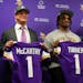 Vikings coach Kevin O'Connell and General Manager Kwesi Adofo-Mensah flank the team's first-round draft picks, J.J. McCarthy and Dallas Turner, on Fri