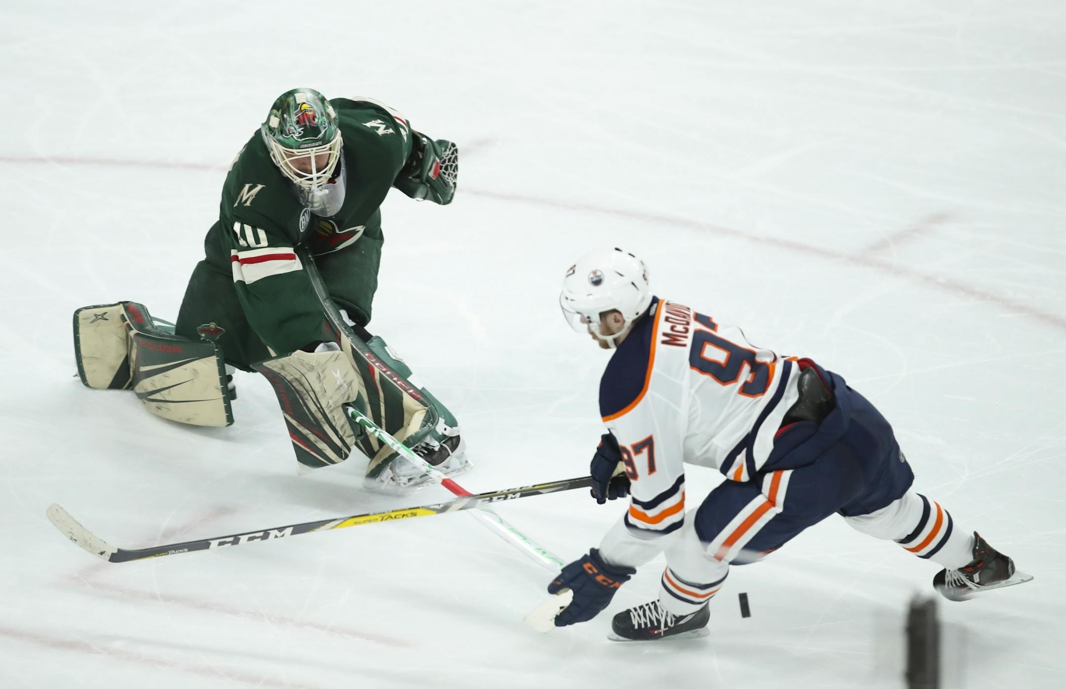 Minnesota Wild goaltender Devan Dubnyk (40) foiled a third period breakaway by Edmonton Oilers center Connor McDavid (97) by coming way out of the crease to poke check the puck away.