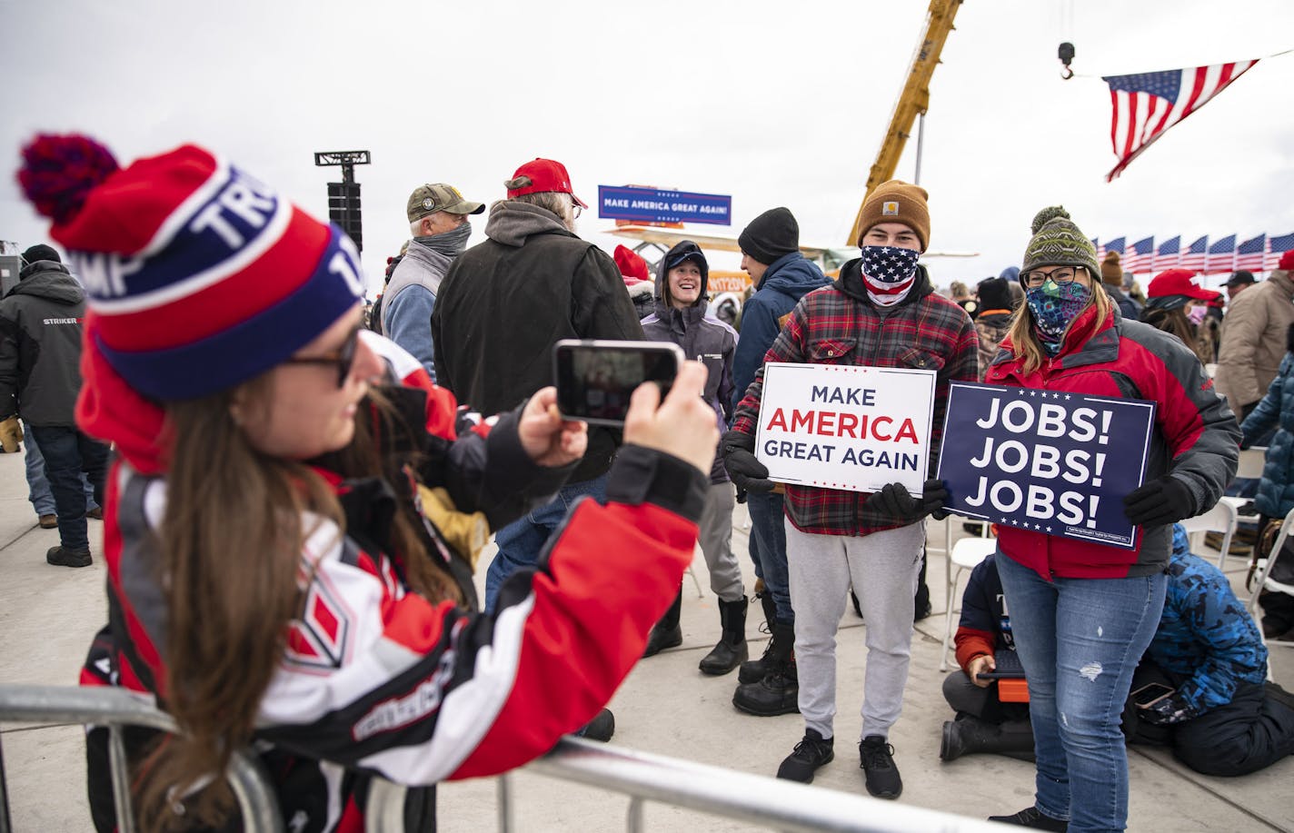 A pair of Trump supporters posed for a photo before the Pence rally in Hibbing, Minn. on Monday. ] ALEX KORMANN • alex.kormann@startribune.com Vice President Mike Pence visited Hibbing, Minn. on Monday October 26, 2020. He held a small rally at the Range Regional Airport despite five of his top aides testing positive for COVID-19 over the weekend.