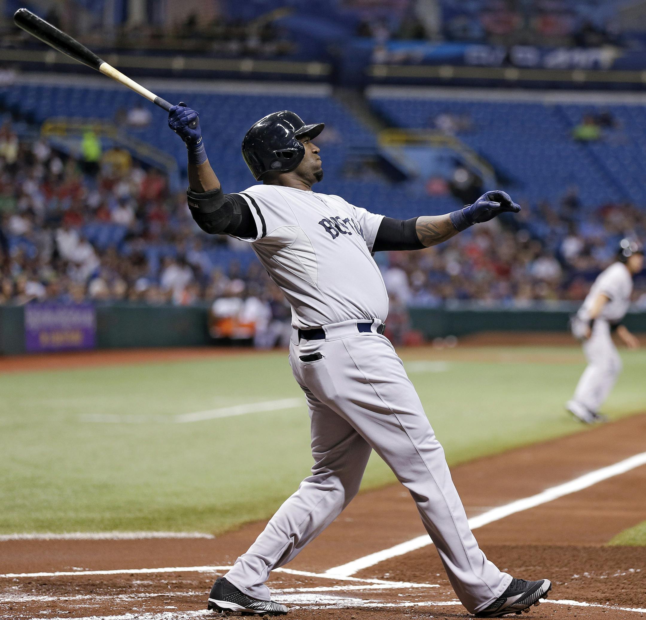 Boston Red Sox's David Ortiz hits a first-inning, three-run home run off Tampa Bay Rays starting pitcher Matt Moore during a baseball game Tuesday, May 14, 2013, in St. Petersburg, Fla. Red Sox's Jacoby Ellsbury, and Shane Victorino also scored on the hit. (AP Photo/Chris O'Meara)