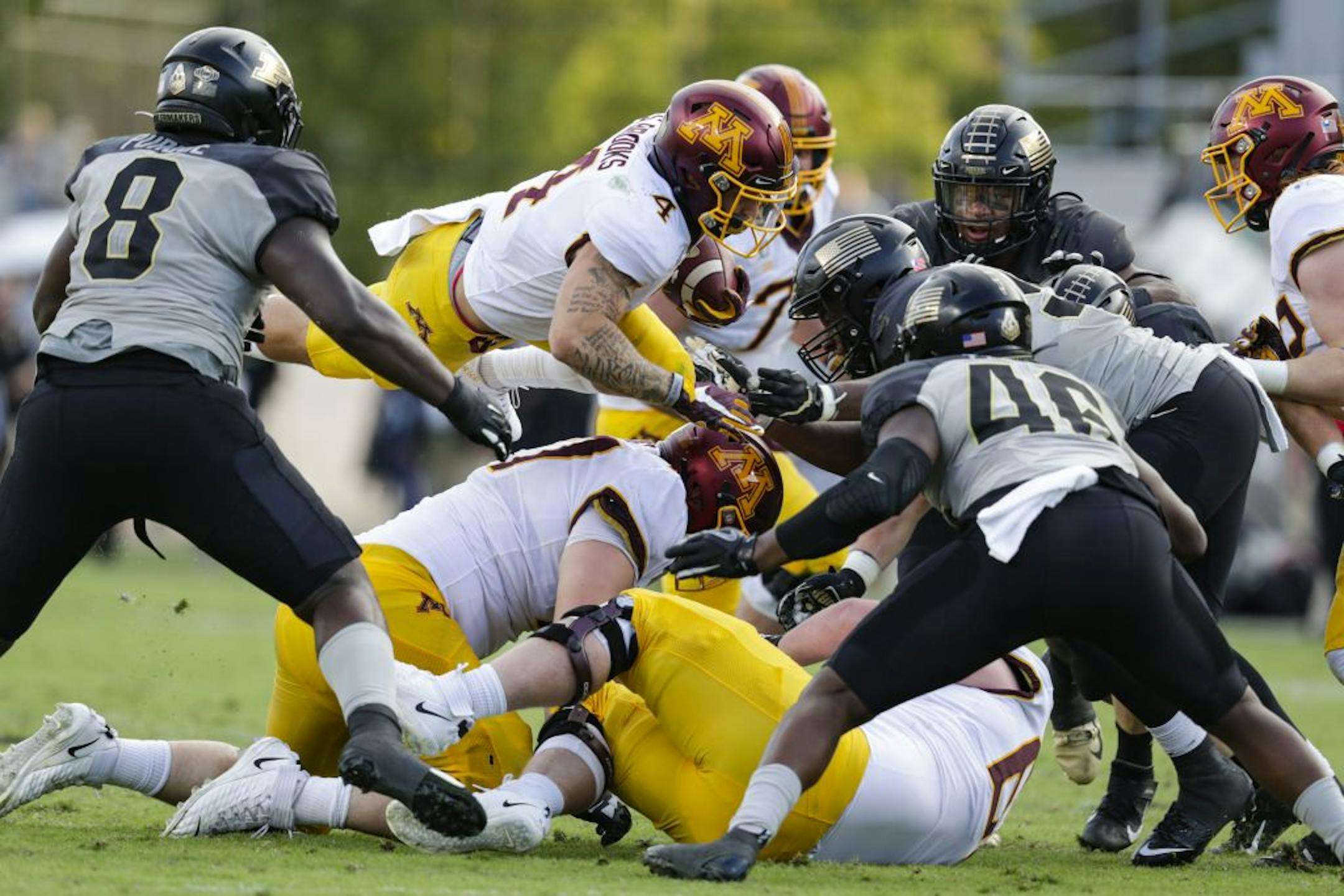 Minnesota running back Shannon Brooks (4) dives to pick up yardage against Purdue during the second half of an NCAA college football game in West Lafayette, Ind., Saturday, Sept. 28, 2019. Minnesota defeated Purdue 38-31.