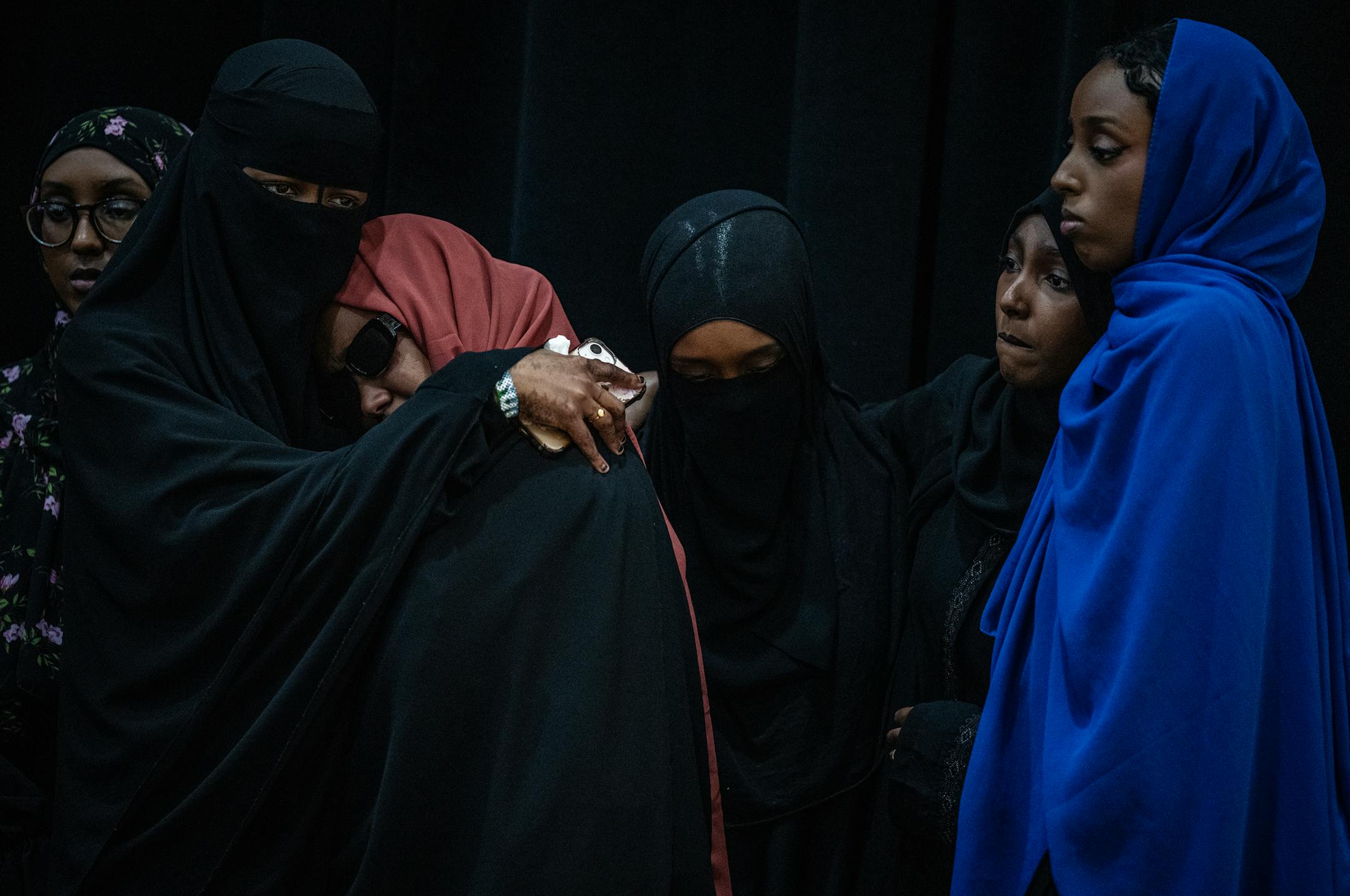 Sundus Adan Odhowa, left, comforts Sundus Mohamoud Ali(red) as they speak at a press conference calling for an independent investigation of a crash that killed five loved ones in Bloomington, Minn., on Monday, June 26, 2023. CAIR-MN is calling for an independent investigation of the crash that killed five in Minneapolis.