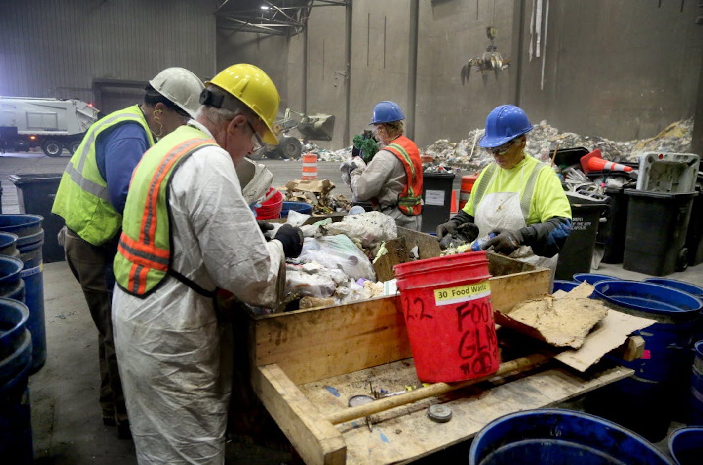 Waste sorters, who are contracted by Hennepin County, sift through trash to check the contents during a week-long study at the Hennepin Energy Recovery Center (HERC) in May 2016.