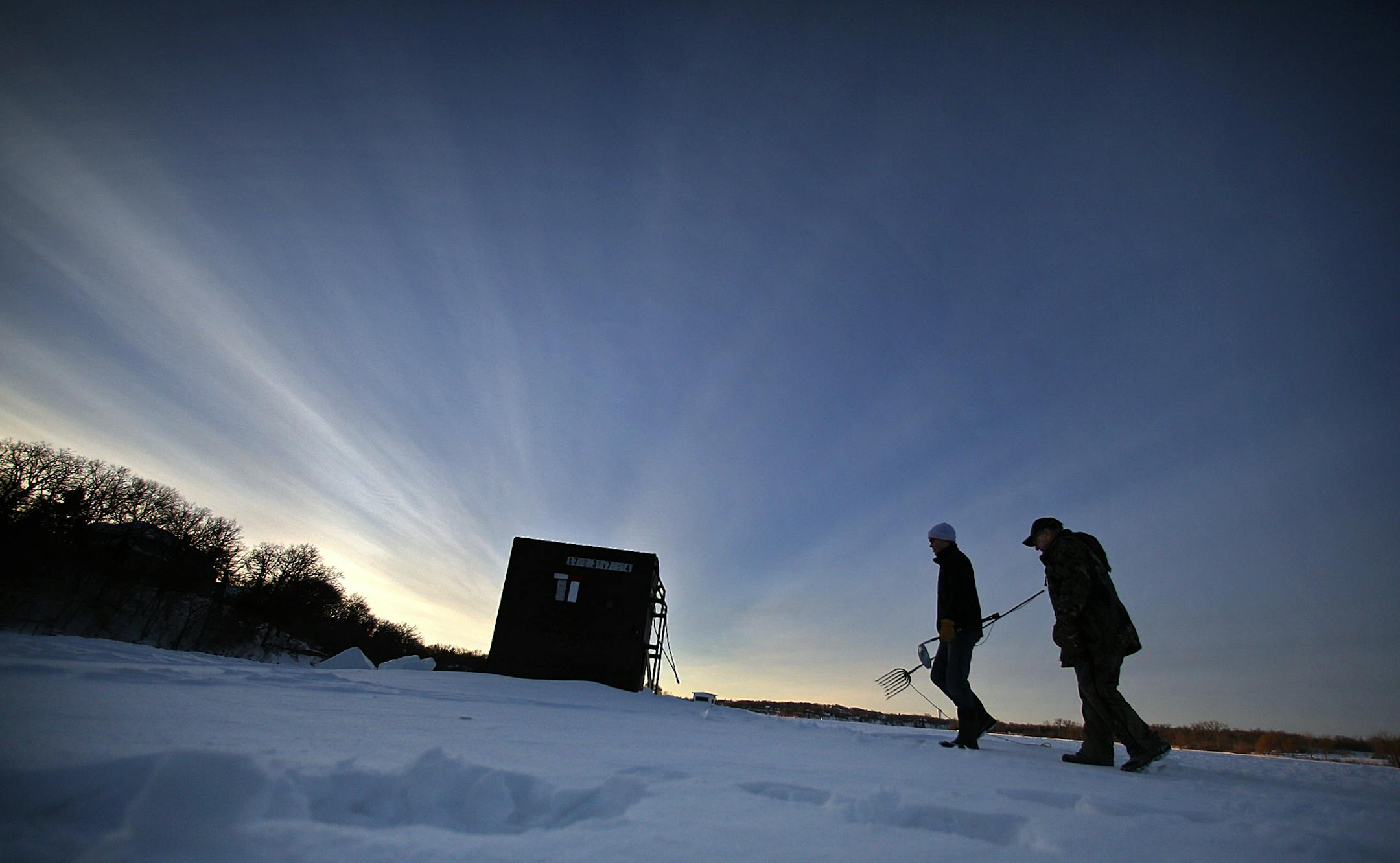 Bill Vogel, 91 (right) and Sam Ringstad, 25, have been spearfishing together for years. The pair recently walked to their fish house on Lake Marion in Lakeville. ] JIM GEHRZ ‚Ä¢ jgehrz@startribune.com / Lakeville, MN / January 21, 2014 / 8:00 AM NOTE: FOR DUETS COLUMN