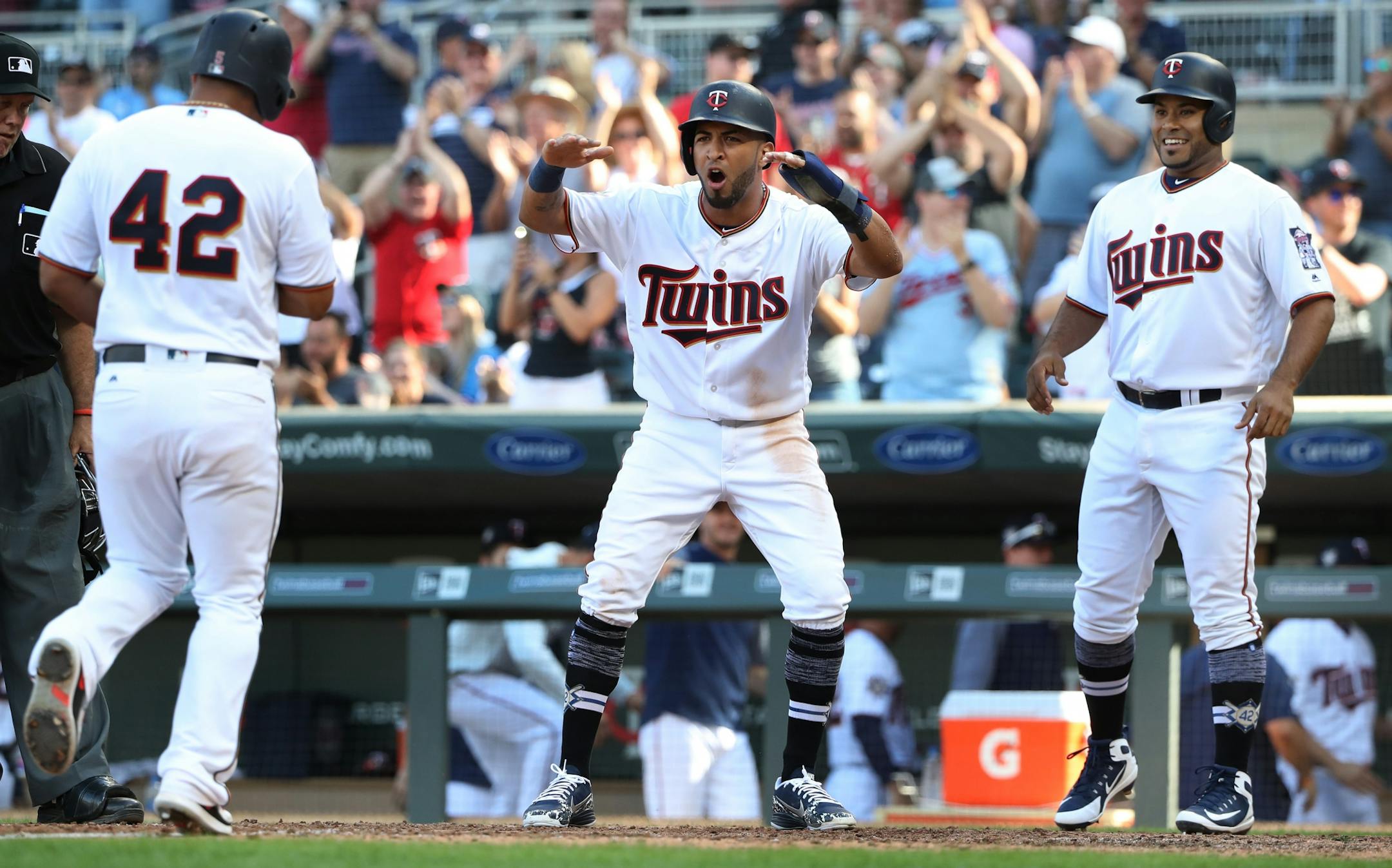 Minnesota Twins left fielder Eddie Rosario center celebrated Eduardo Escobar 3 run homer as pinch runner Gregorio Petit in the eight inning looked on June 5, 2018 in Minneapolis , MN.