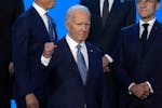 President Joe Biden pumps his fist as he poses with NATO leaders for an official photo at the NATO summit in Washington on Wednesday.