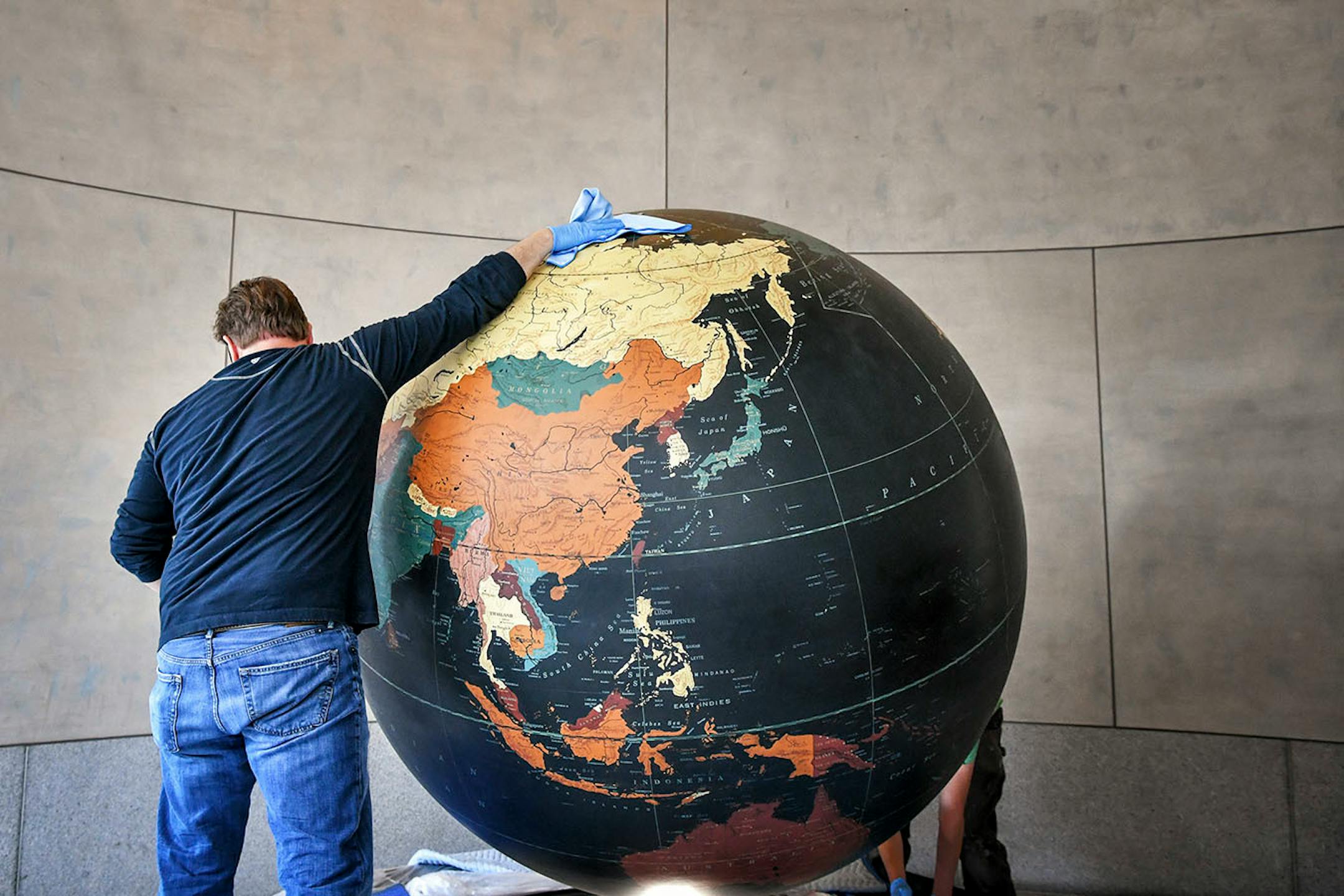 Workers from Blue Rhino Studio in Eagan handled the restoration and placement of the Star Tribune globe.
