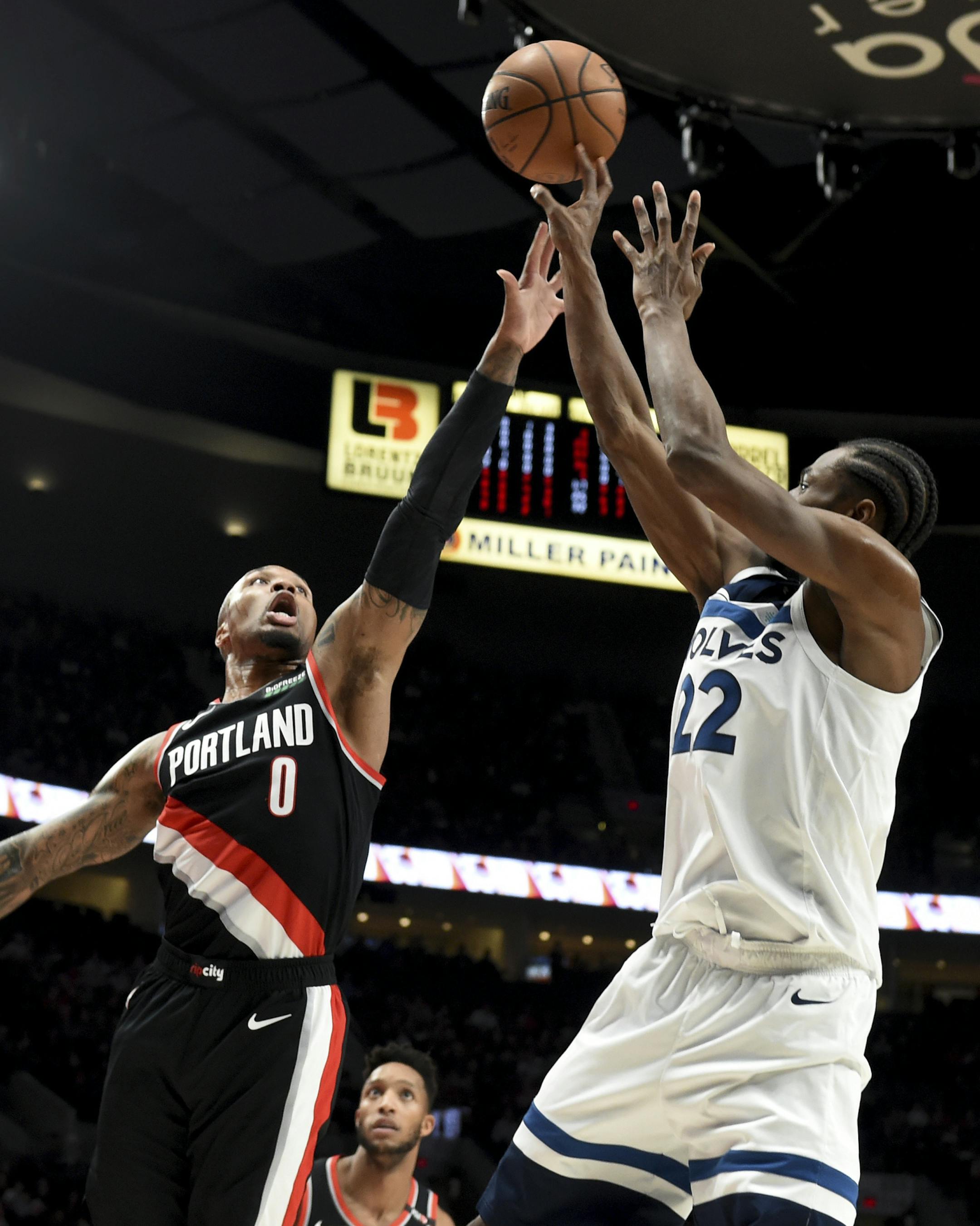 Minnesota Timberwolves forward Andrew Wiggins, right, shoots over Portland Trail Blazers guard Damian Lillard during the first half of an NBA basketball game in Portland, Ore., Saturday, Dec. 8, 2018. (AP Photo/Steve Dykes)