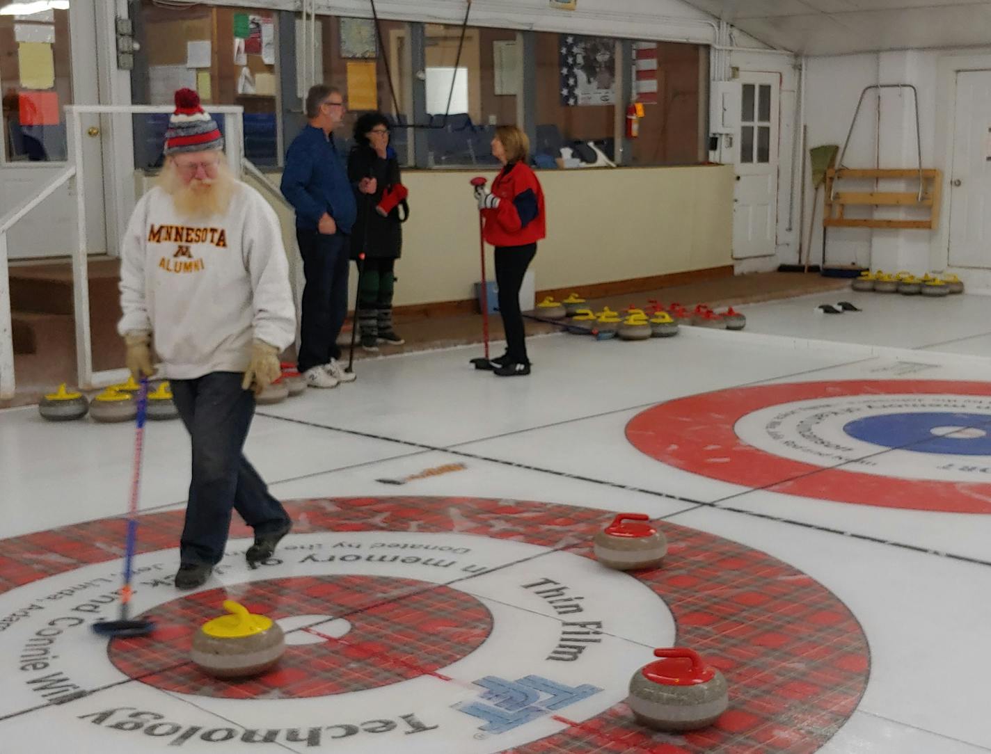 Larry Barott tends the house at the Heather Curling Club in Mapleton, Minn., which claims to be the birthplace of Minnesota curling. In the background, from left, are the Rev. Steve Berkeland, Judy Berkeland and Linda Anniss.