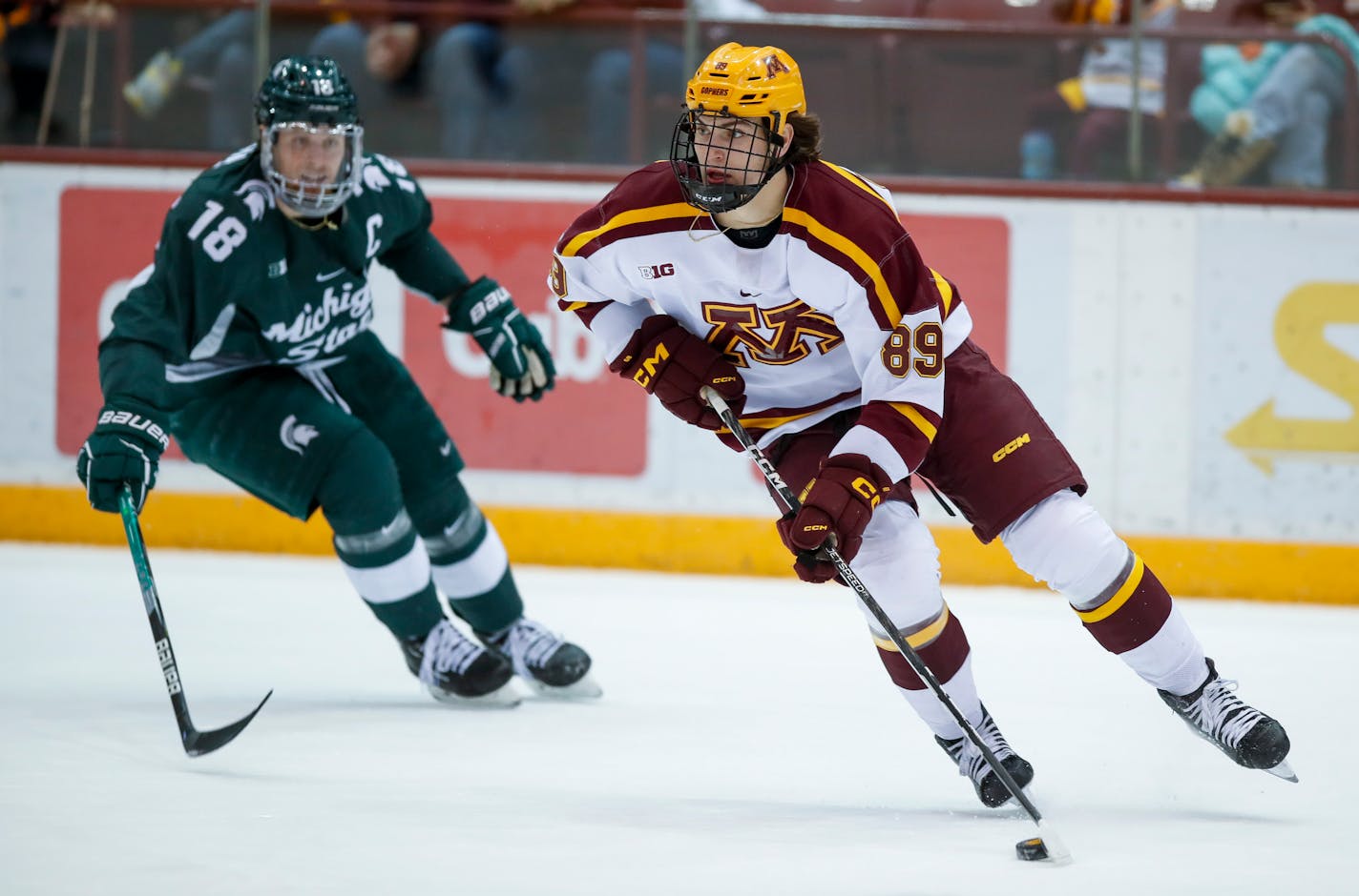 Gophers forward Matthew Knies (89) skated away from Michigan State captain Miroslav Mucha (18) on Friday Jan. 27, 2023 at 3M Arena at Mariucci in Minneapolis. (Eric Miller, Gophers athletics)