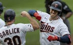 Mitch Garver (8) of the Minnesota Twins was greeted by Kyle Garlick (30) after hitting a three run homer in the third inning.