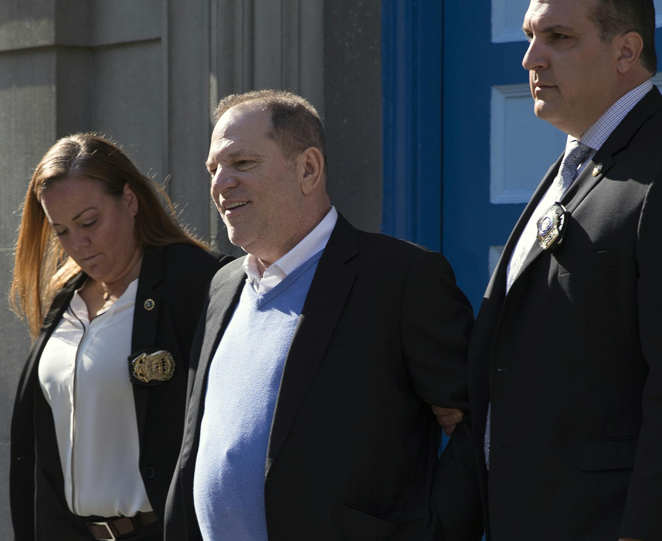 A handcuffed Harvey Weinstein is led out of a police station in lower Manhattan following his arrest on Friday morning, May 25, 2018. Weinstein was arrested by detectives on Friday on charges that he raped one woman and forced another to perform oral sex, capping a lengthy inquiry into the avalanche of accusations against him that spawned a public reckoning, and, with it, the global #MeToo movement. (JuliAnna Patino/The New York Times)