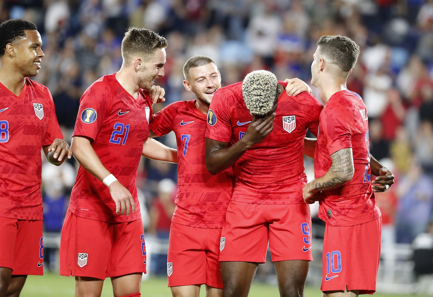 Teammates celebrate with USA forward Gyasi Zardes (9), second from right, after he scored a goal that deflected in off of his face in the June 18 match against Guyana at Allianz Field. From left are Weston Mckennie (8), Tyler Boyd (21), Paul Arriola (7) and Christian Pulisic (10).