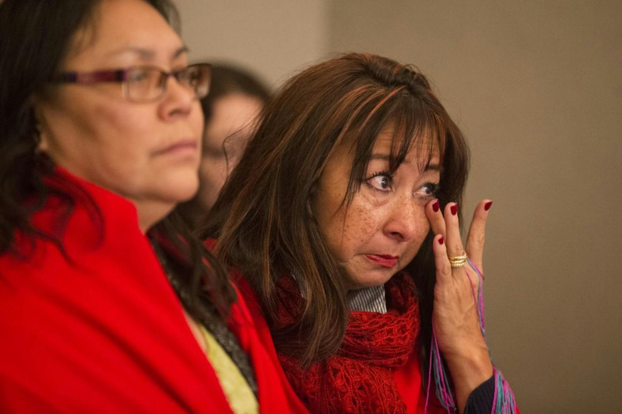 Debra Poitra of the Minnesota Indian Women's Sexual Assault Coalition (MIWSAC) wipes away tears during a press conference held by the Minnesota Coalition for Battered Women at the State Office Building in St. Paul on Tuesday, January 26, 2016.