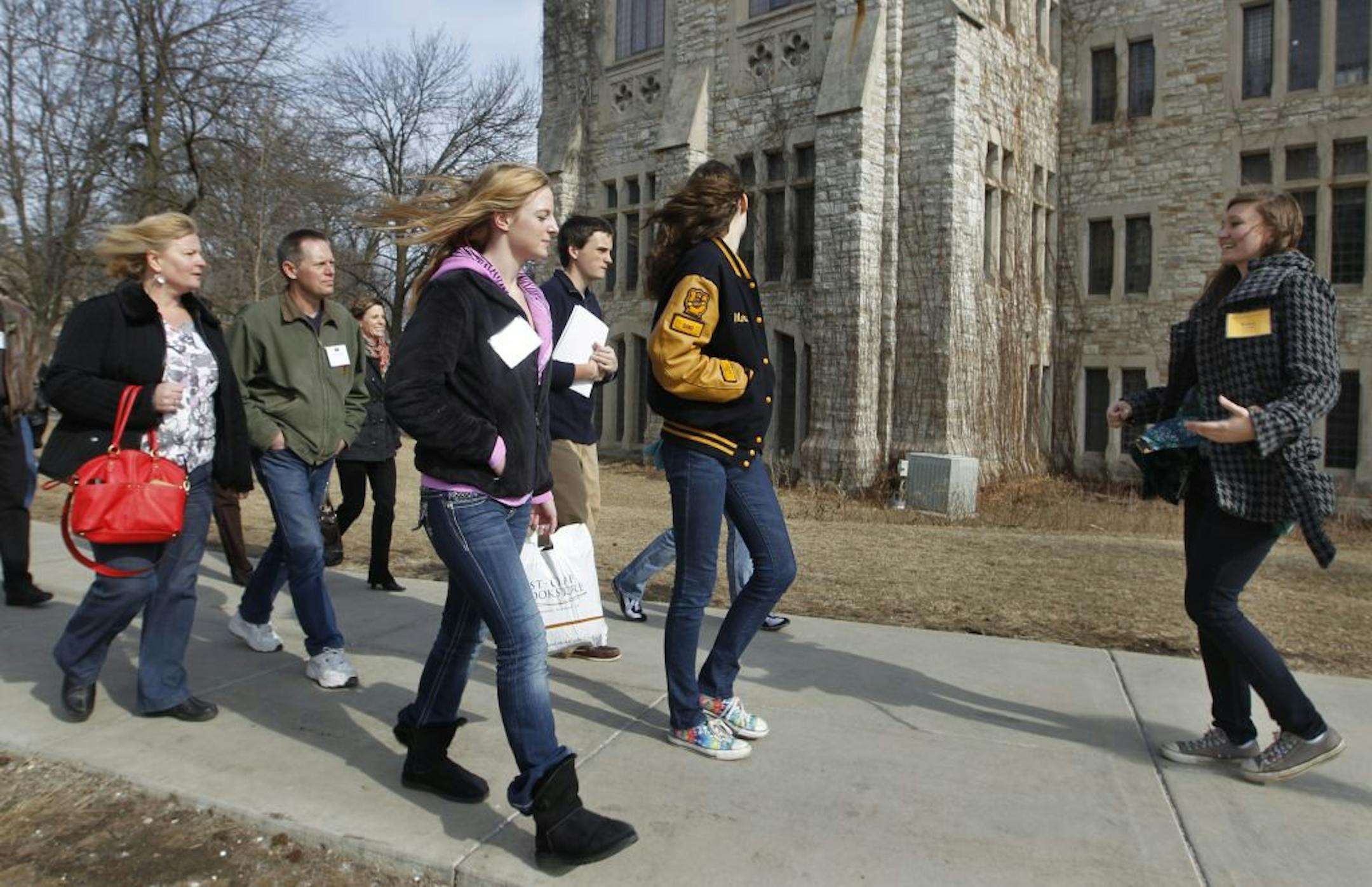 During an admissions tour at St. Olaf College in Northfield, Jody Heikkinen, left, her husband, Greg, and daughter Kirsten Heikkinen listened to tour guide Kelsey Gorman. Kirsten is considering studying math and is weighing several small liberal arts schools.