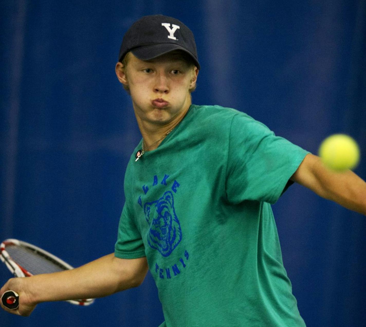 Charlie Adams, from Blake, returns the ball to Breck's Dan Carpenter during individual tennis competition Thursday afternoon at the Reed-Sweatt Tennis Center. Dan Carpenter won 6-1 , 6-4.