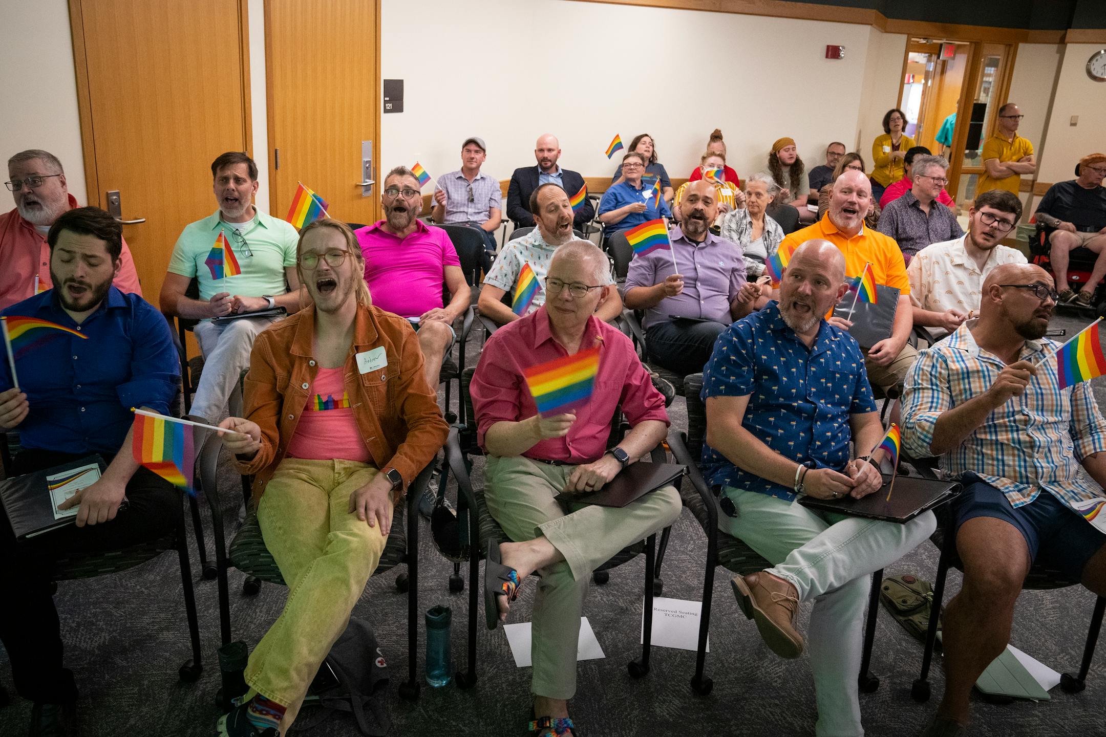 All the guests, including members of the Twin Cities Gay Men's Chorus Chamber Singers in the first two rows, sang "Somewhere Over the Rainbow" while waving rainbow flags to end the celebration of life for Jean-Nickolaus Tretter.