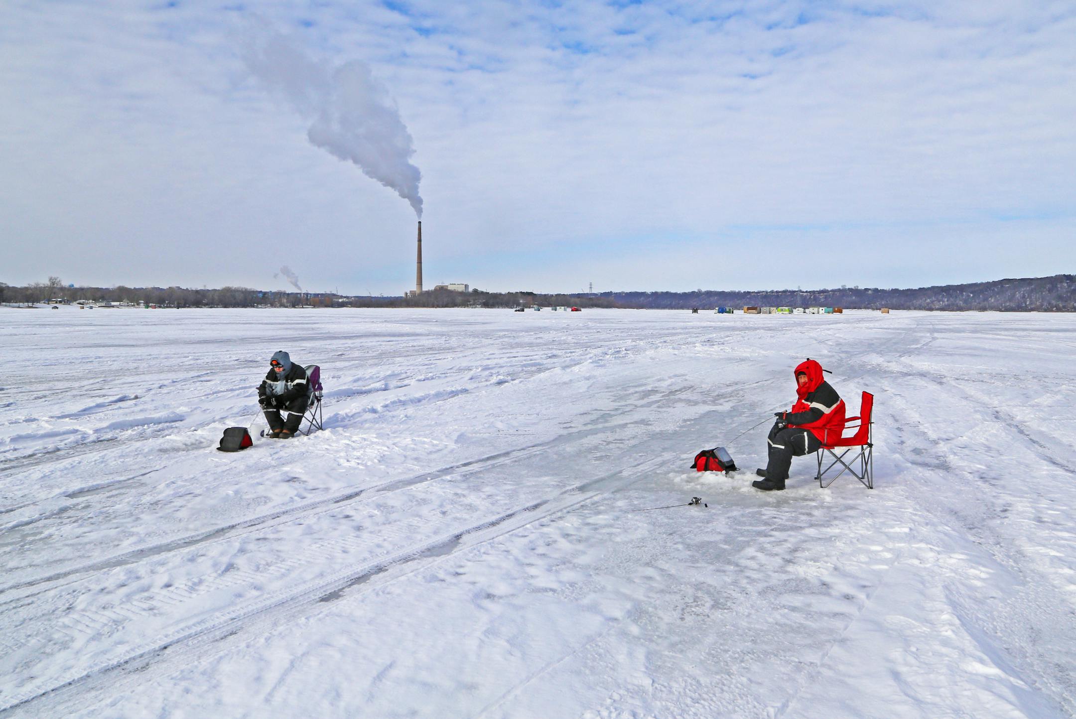 Blong Xiong, left, of St. Paul and his cousin, Chang Xiong, also of St. Paul, fished on the frozen St. Croix River last week, hoping to hook a crappie or two. The pair had just returned from ice fishing on Lake of the Woods. They also fish the river in the summer.