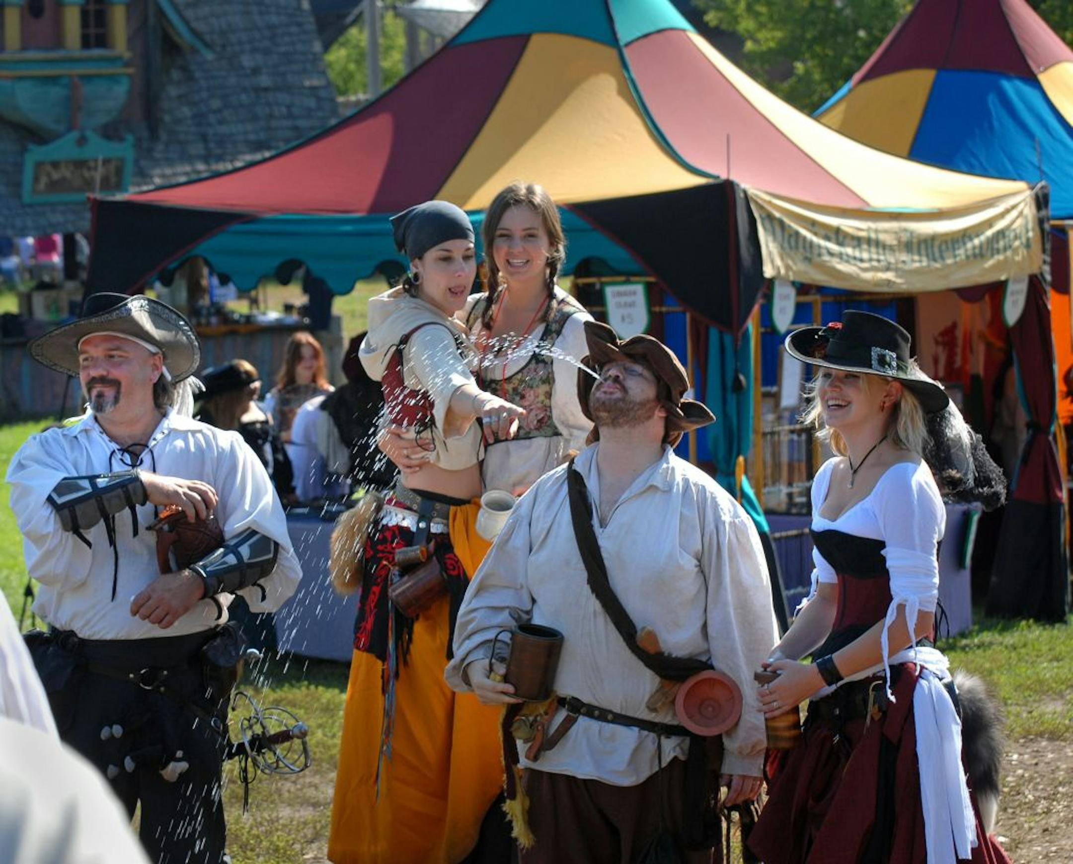 Shakope, Mn. Saturday 8/22/ The Minnesota Renaissance Fair opening day. These renaissance actors were getting into character with a baudy shower.