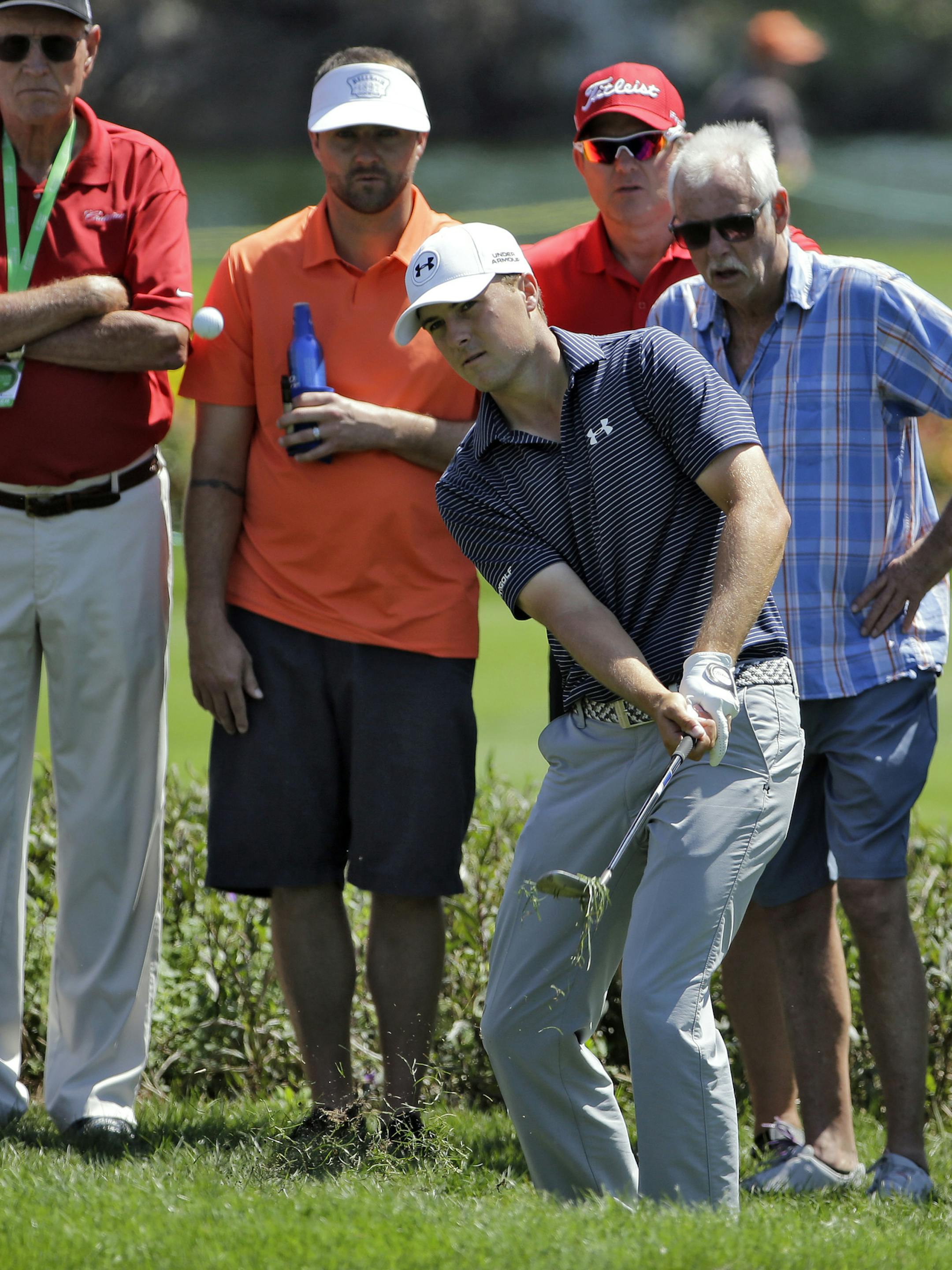 Jordan Spieth chips from in front of the gallery on the first hole during the final round of the Valspar Championship golf tournament Sunday, March 15, 2015, at Innisbrook in Palm Harbor, Fla. (AP Photo/Chris O'Meara)