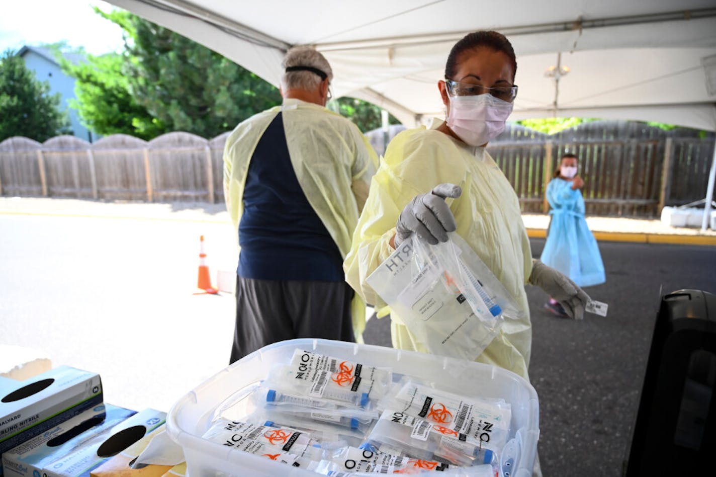 A North Memorial health care worker grabbed a fresh COVID-19 test kit this week at a drive-up site in Robbinsdale.