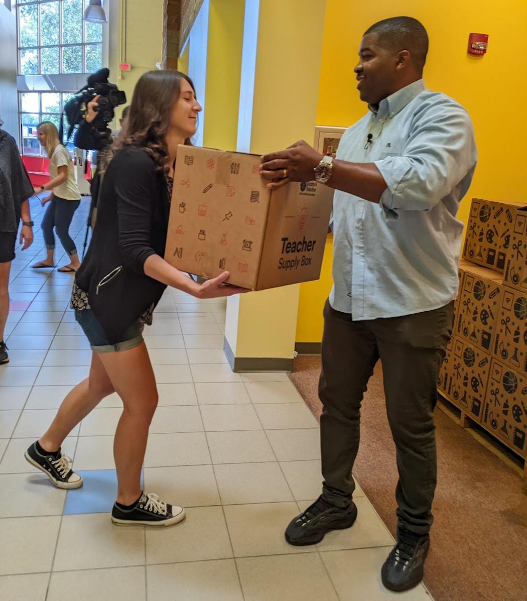 Angelina Bochkarov, left, a special-ed teacher at Excell Academy For Higher Learning in Brooklyn Park, received a box of school supplies from Justin Baylor, who with his father, Tim, owns and operates 11 McDonald’s restaurants in the Twin Cities area.