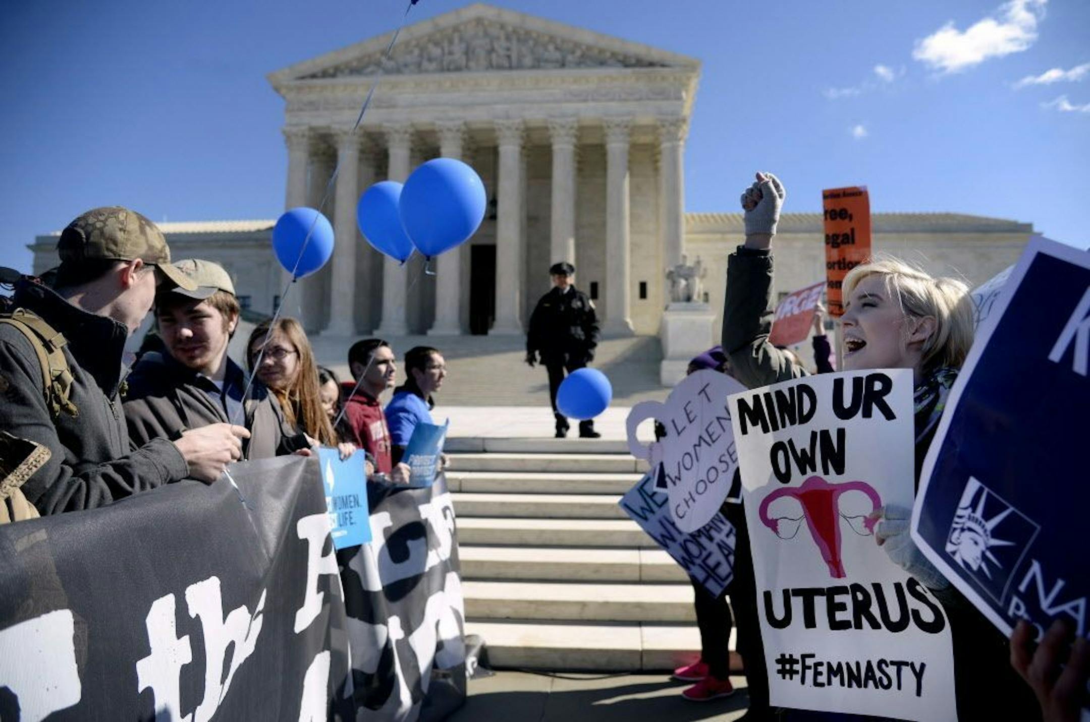 Supporters of legal access to abortion, as well as anti-abortion activists, rally outside the Supreme Court on March 2, 2016, as the Court hears oral arguments in the case of Whole Woman's Health v. Hellerstedt, which deals with access to abortion, in Washington, D.C.