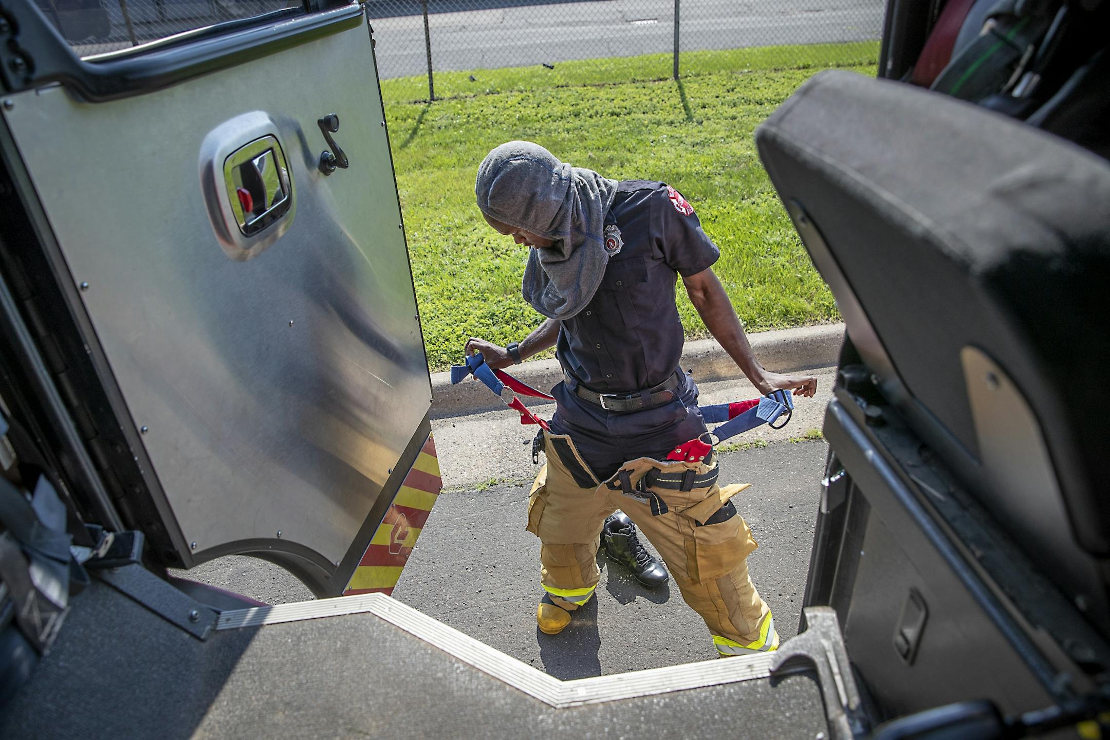 St. Paul firefighter Mohamed Daoud quickly put on gear for a fire call during his second day on the job as one of the first Somali Americans to be sworn into the St. Paul fire department.