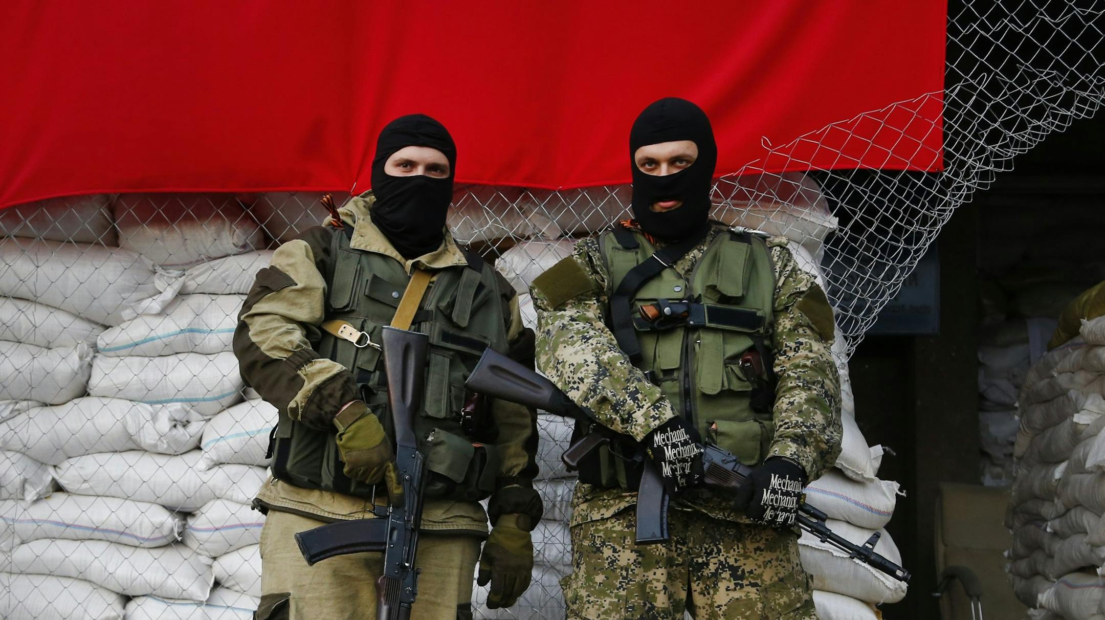 Armed Pro-Russian men guard barricades in front of city hall in Slovyansk, eastern Ukraine, Monday, April 21, 2014. The self-proclaimed mayor of Slovyansk in eastern Ukraine, Vacheslav Ponomarev is appealing to Russia to send in peacekeeping troops after a shootout at checkpoint near the city manned by pro-Russia insurgents. (AP Photo/Sergei Grits)