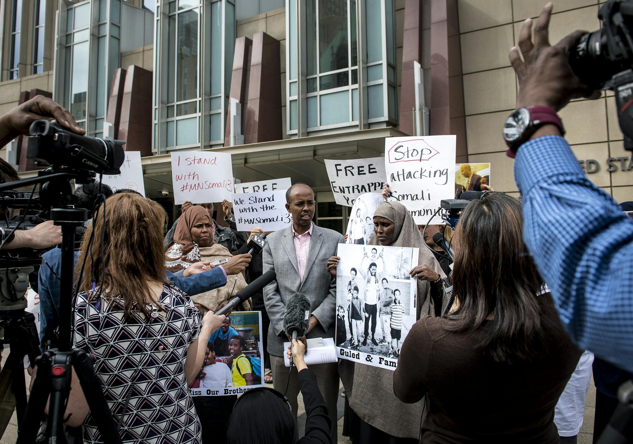 Somali community activist Sadik Warfa, center, acted as a translator for Ayan Farah, to his immediate left and Fadumo Hussein, to his right, during a press conference held after court let out Tuesday outside the US Federal Courthouse. Farah and Hussein are the mothers of Mohamed Abdihamid Farah and Guled Ali Omar, two of the three men on trial for attempting to join ISIL. ] (AARON LAVINSKY/STAR TRIBUNE) aaron.lavinsky@startribune.com Closing arguments began Tuesday in the federal ISIL recruit tr