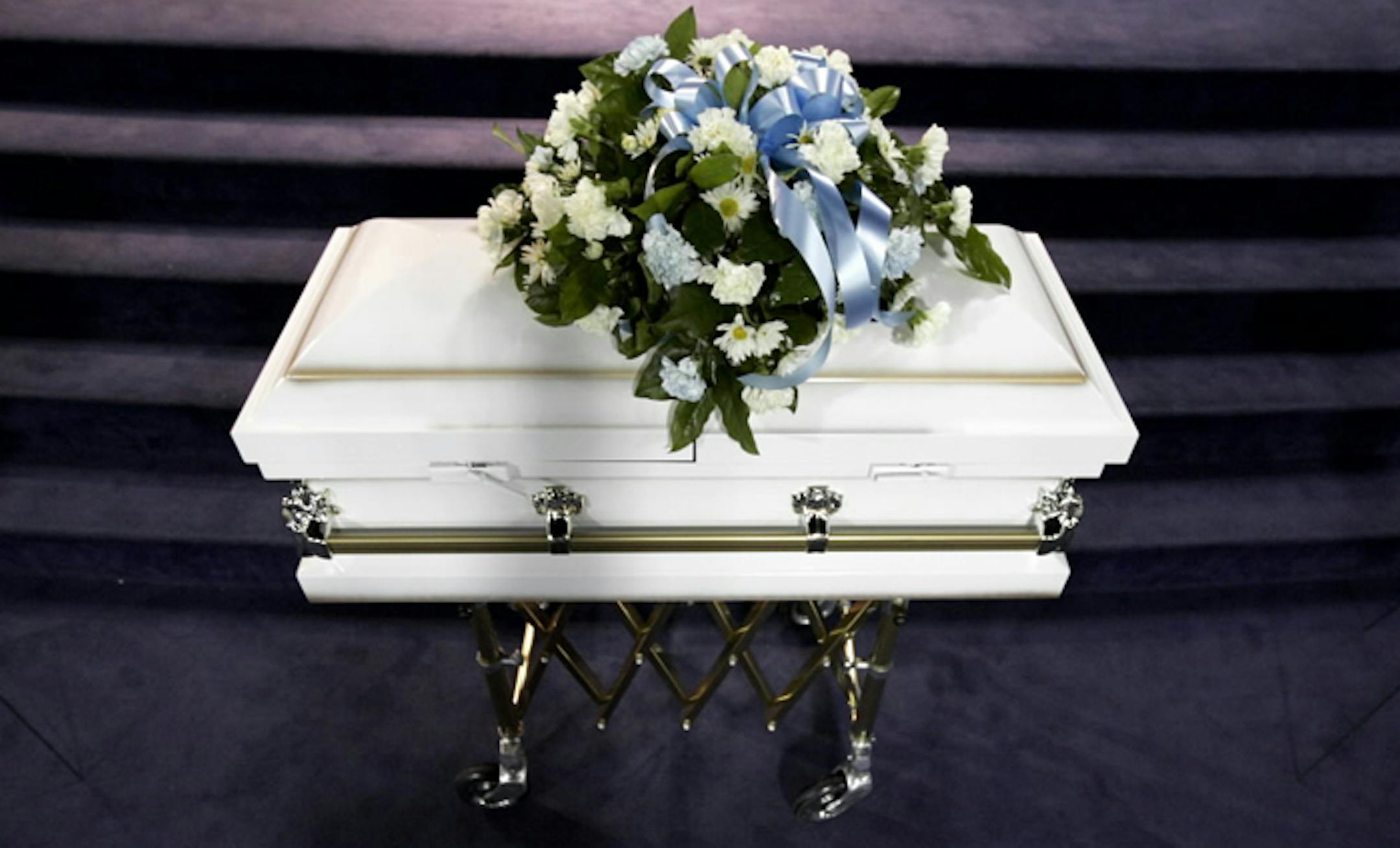 The little white casket was open during the wake Monday night. It was closed during the funeral, but then opened again at the end of the service.