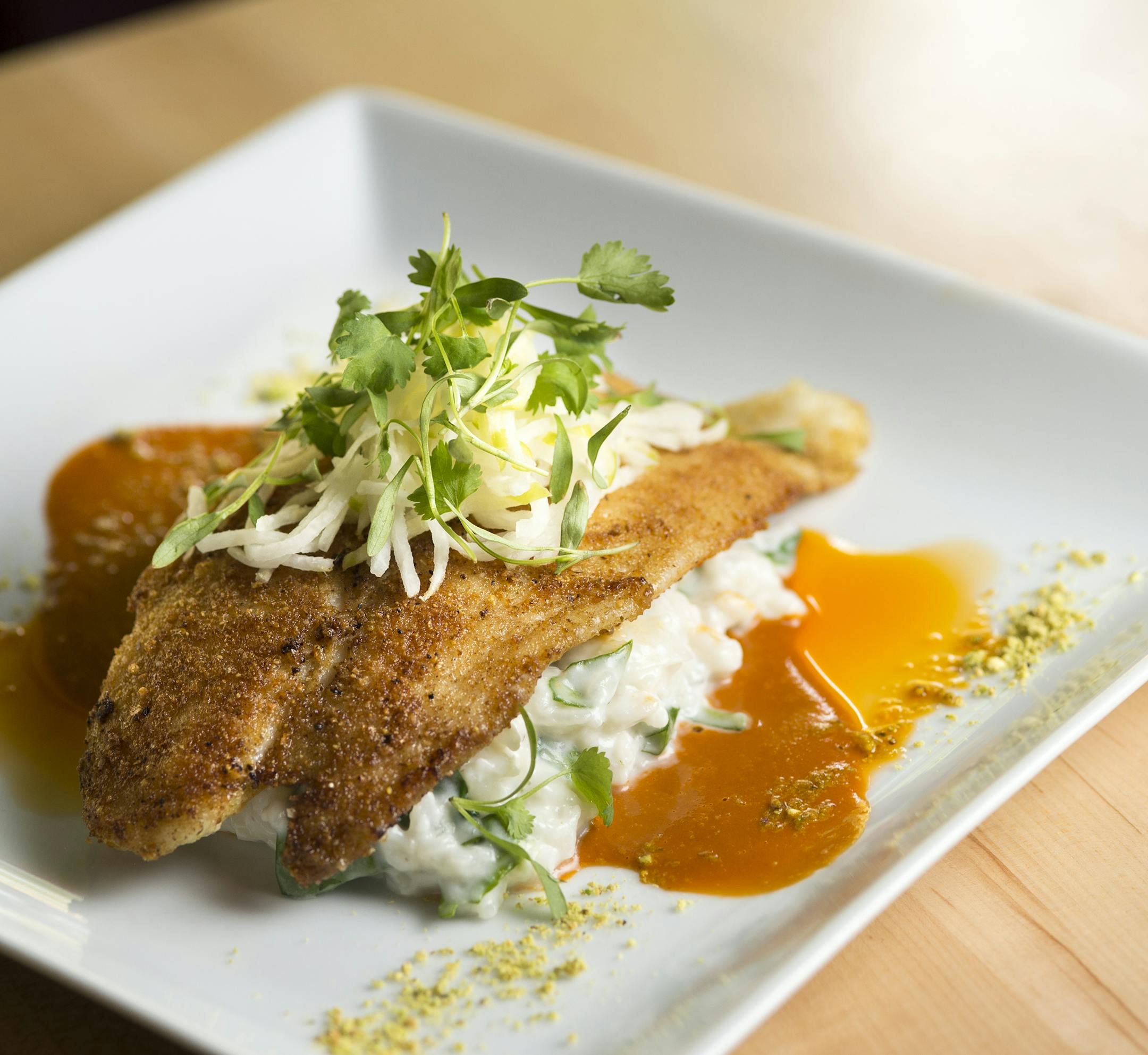 Pistachio- and toasted guajillo-crusted grouper over coconut risotto, with agave-tomato sauce and a green apple-fennel slaw.