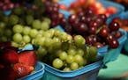 Strawberries, grapes, cherries, and other produce sat out for sale at the Patnode's stand, which workers say is the oldest at the farmers market. ] AN