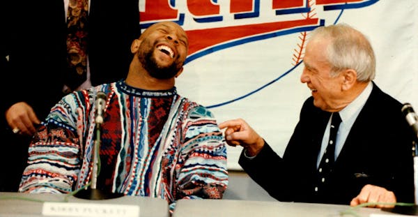 December 4, 1992 Kirby signs with Twins. photo 1. Kirby Puckett left, enjoys the moment after signing a five-year, $30 million contract with Carl Pohl