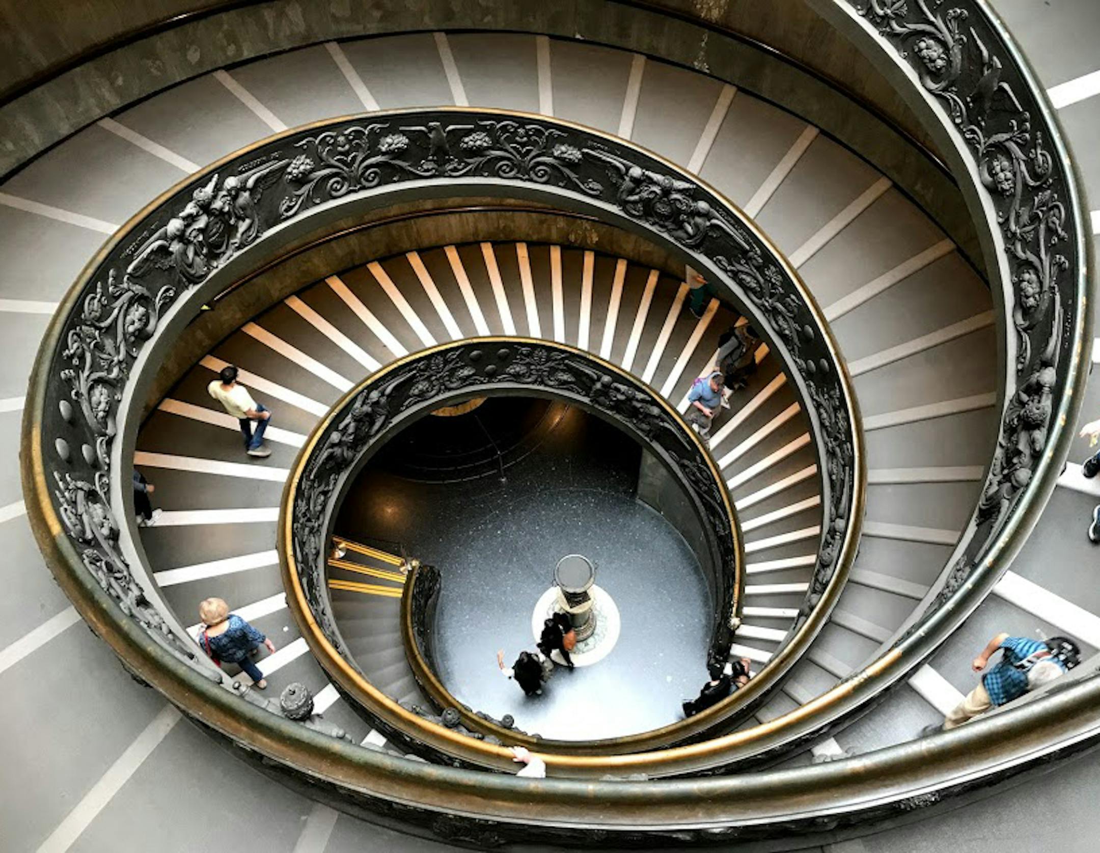 After a day of viewing countless art treasures and being reluctant to leave the Vatican Museums Gary and Ruth Stamm encountered one more treasure…the breathtaking Bramante Staircase. This modern double helix staircase was designed by architect Giuseppe Momo in 1932 to give spectators a truly dizzying experience before they leave the incredible masterpieces in the museum. It is composed of two staircases which theoretically allow people to go up and down without crossing each other. Its inspirati
